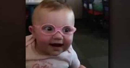 Seven months old baby smiles from the happiness of being able to see after surgery.