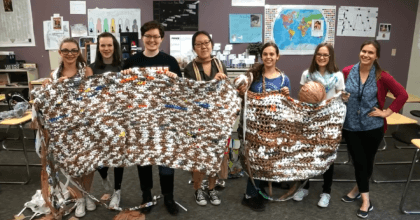 High school students using plastic bags to make sleeping mats for the homeless.