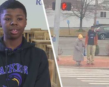 Teen helps out a blind elderly woman cross the street