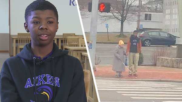 Teen helps out a blind elderly woman cross the street