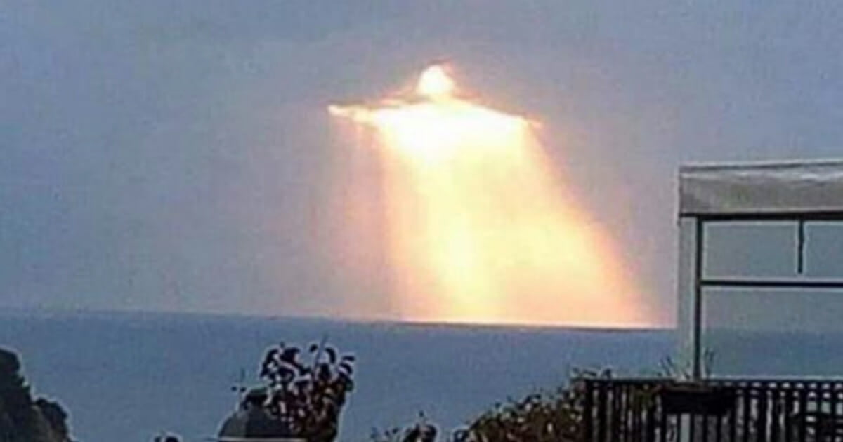 Figure resembling the statue of Christ the Redeemer appears in the sky