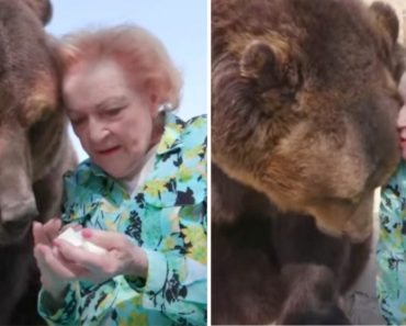 Actress Betty White, who turned 99 this year, gives a grizzly bear a kiss