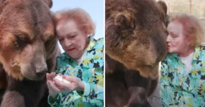 Actress Betty White, who turned 99 this year, gives a grizzly bear a kiss