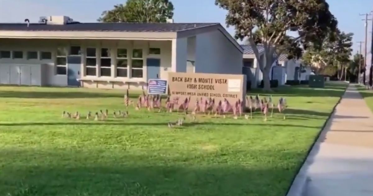 Teacher who rejected The Star-Spangled Banner faces fury as parents decorate the school area with US flags