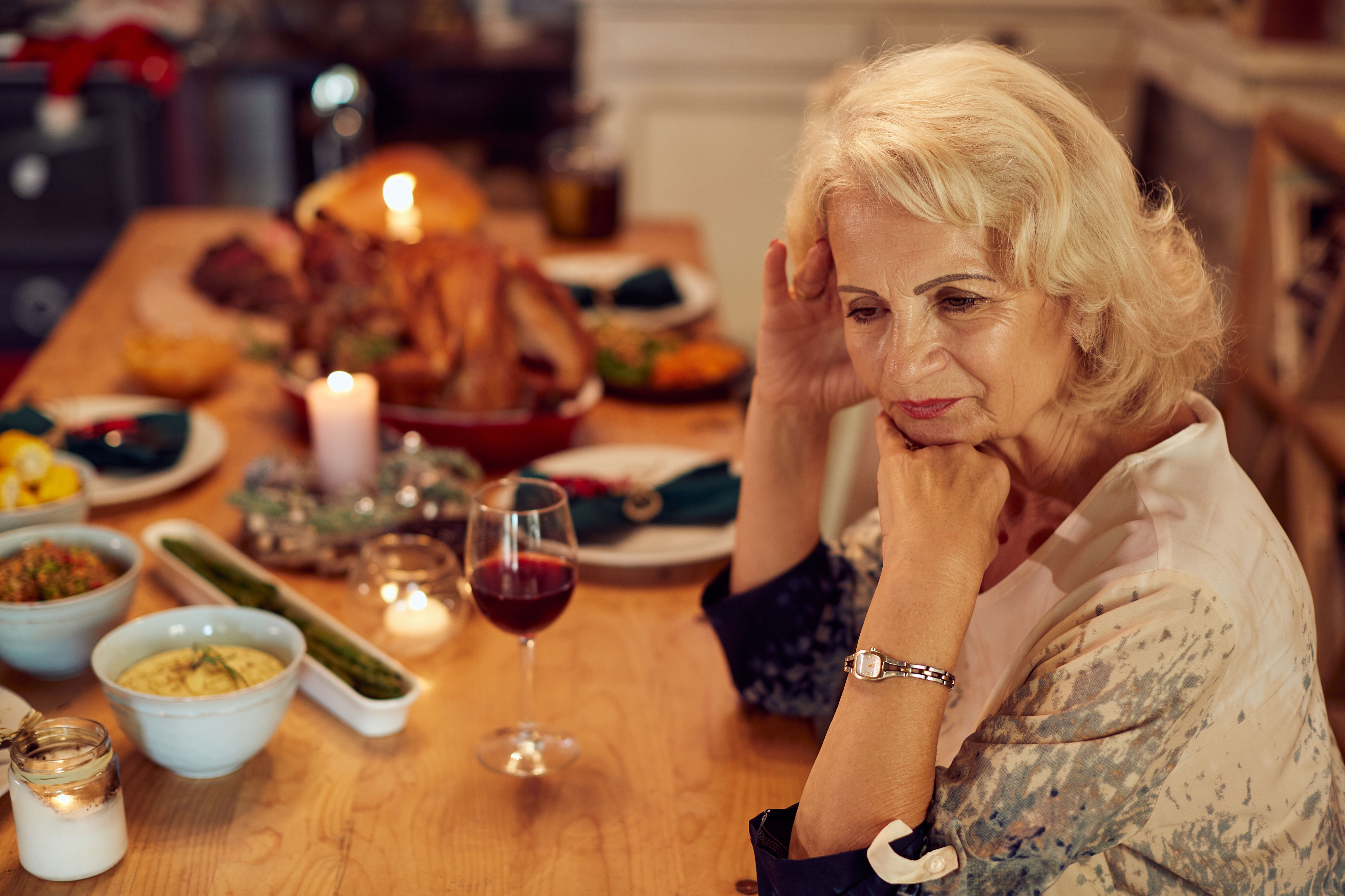 An elder woman upset at a dinner table. | Source: Getty Images