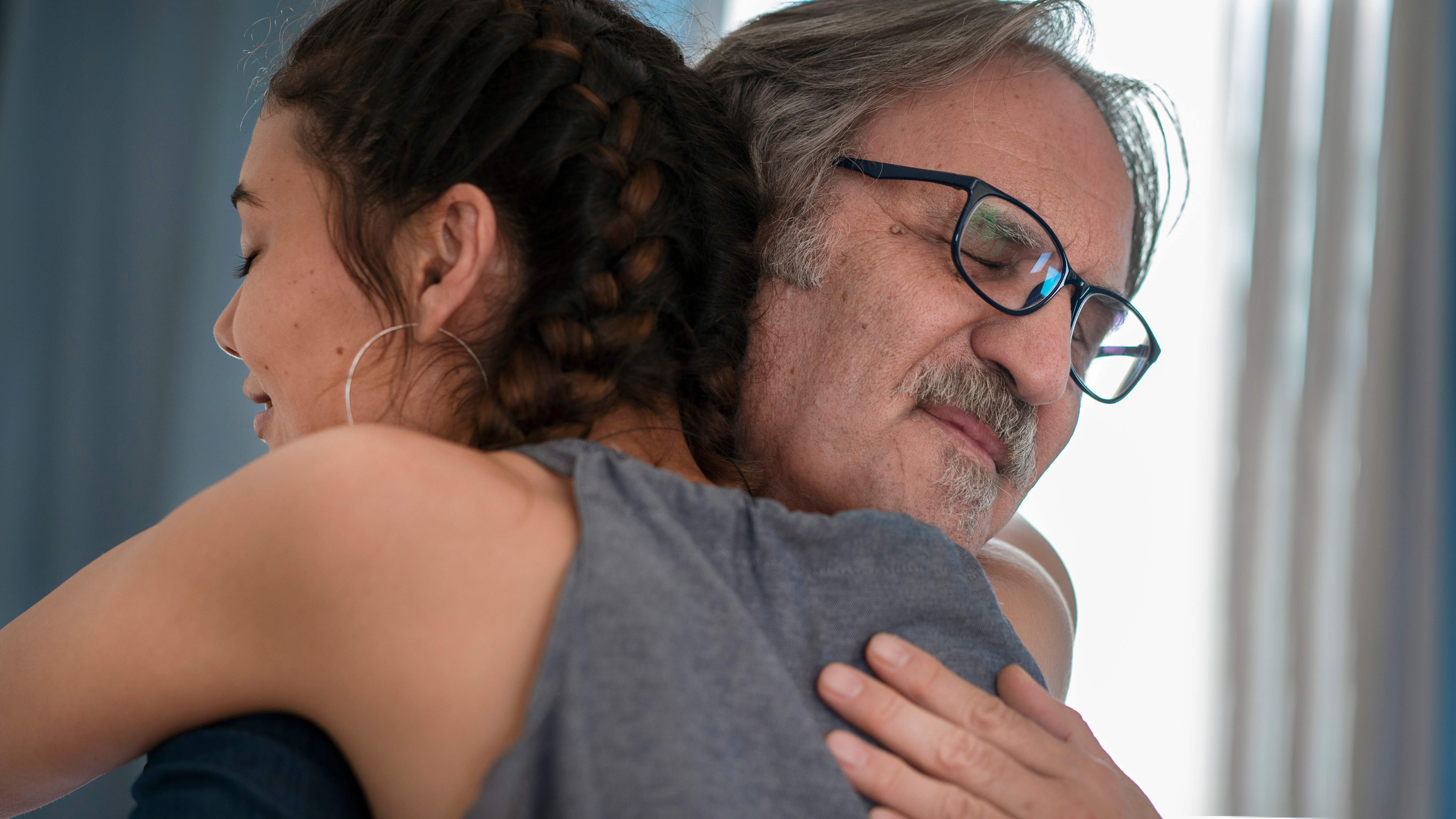 A man hugs his daughter | Source: Shutterstock