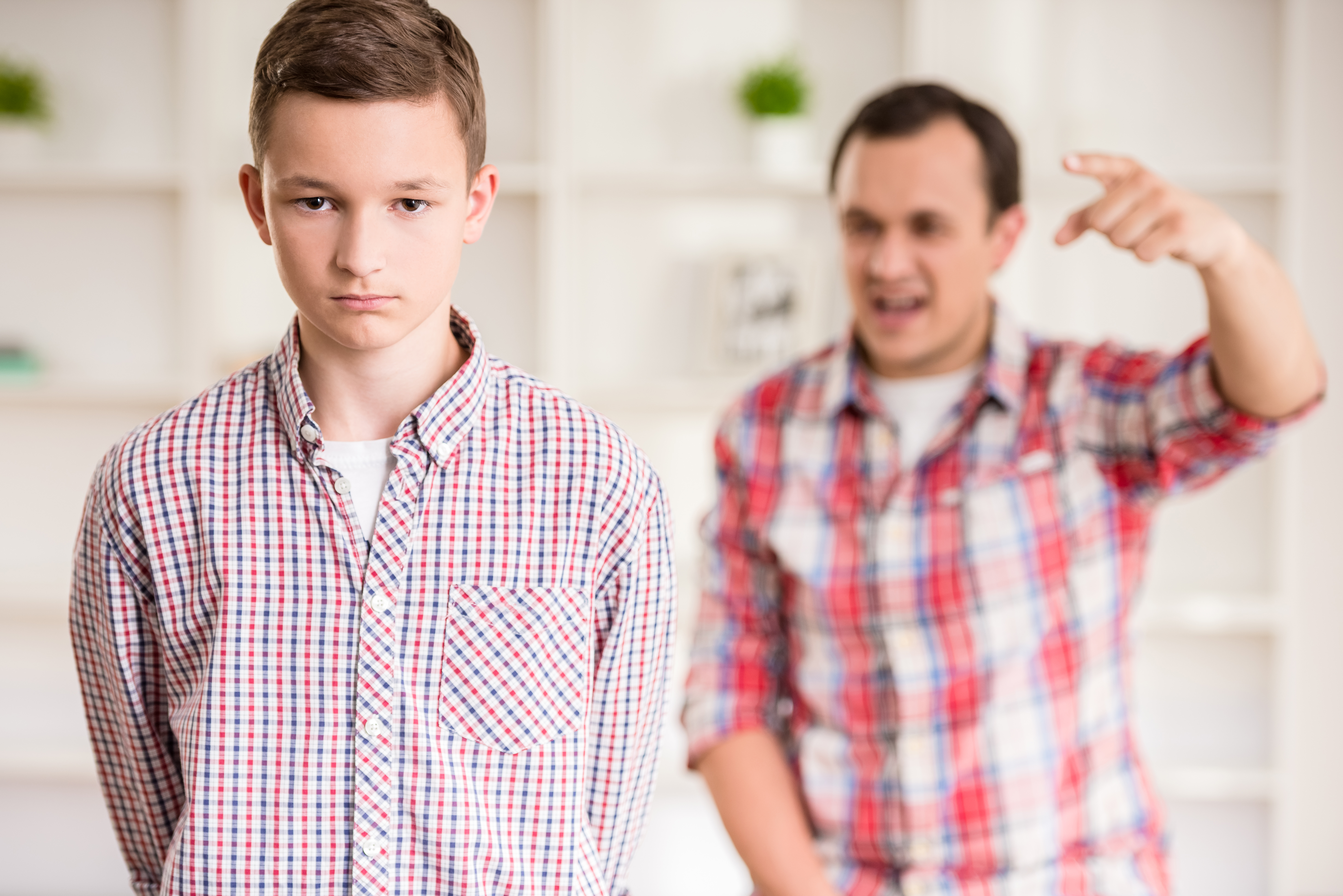 A young boy being scolded by his father | Source: Shutterstock