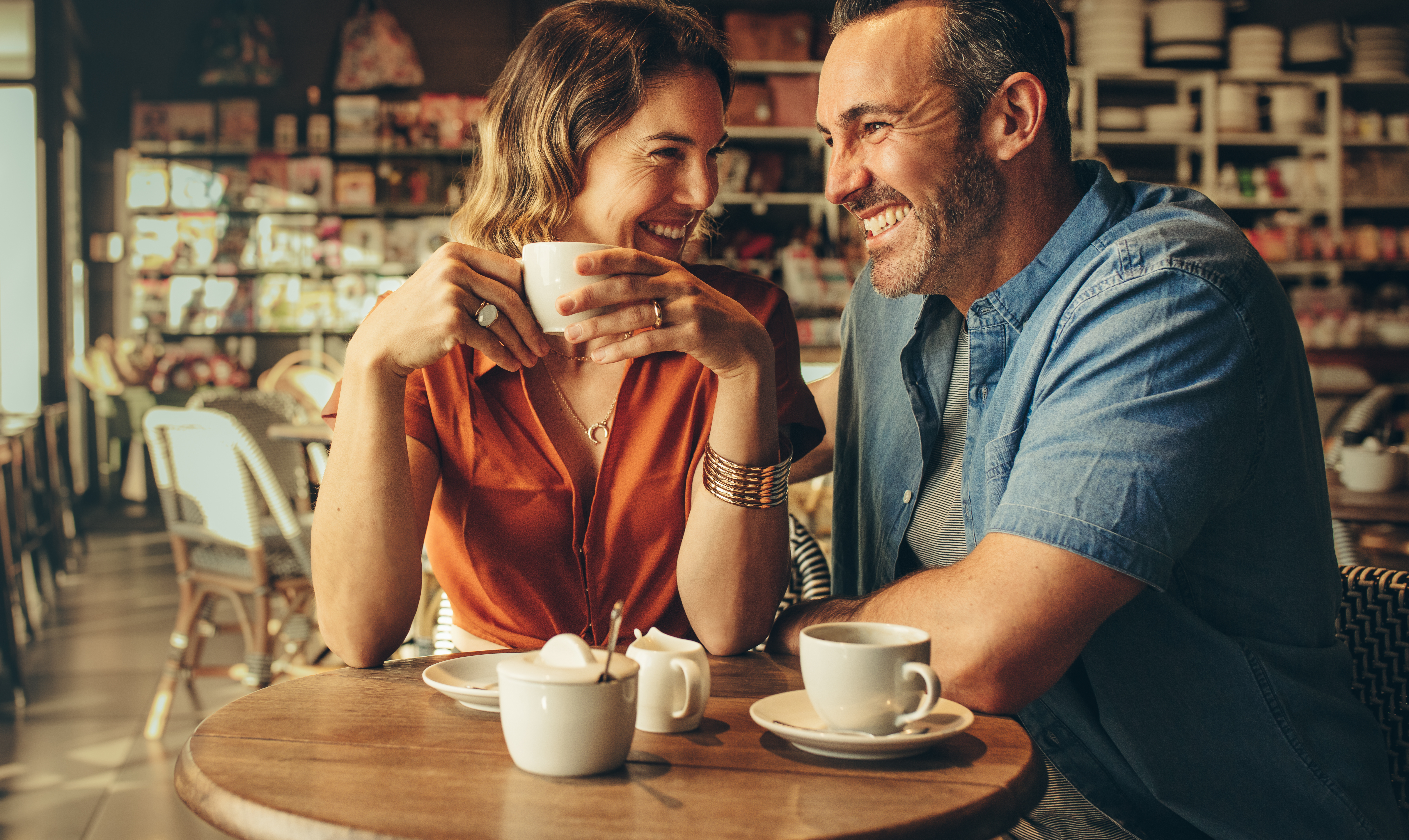 A happy couple laughing over coffee | Source: Shutterstock