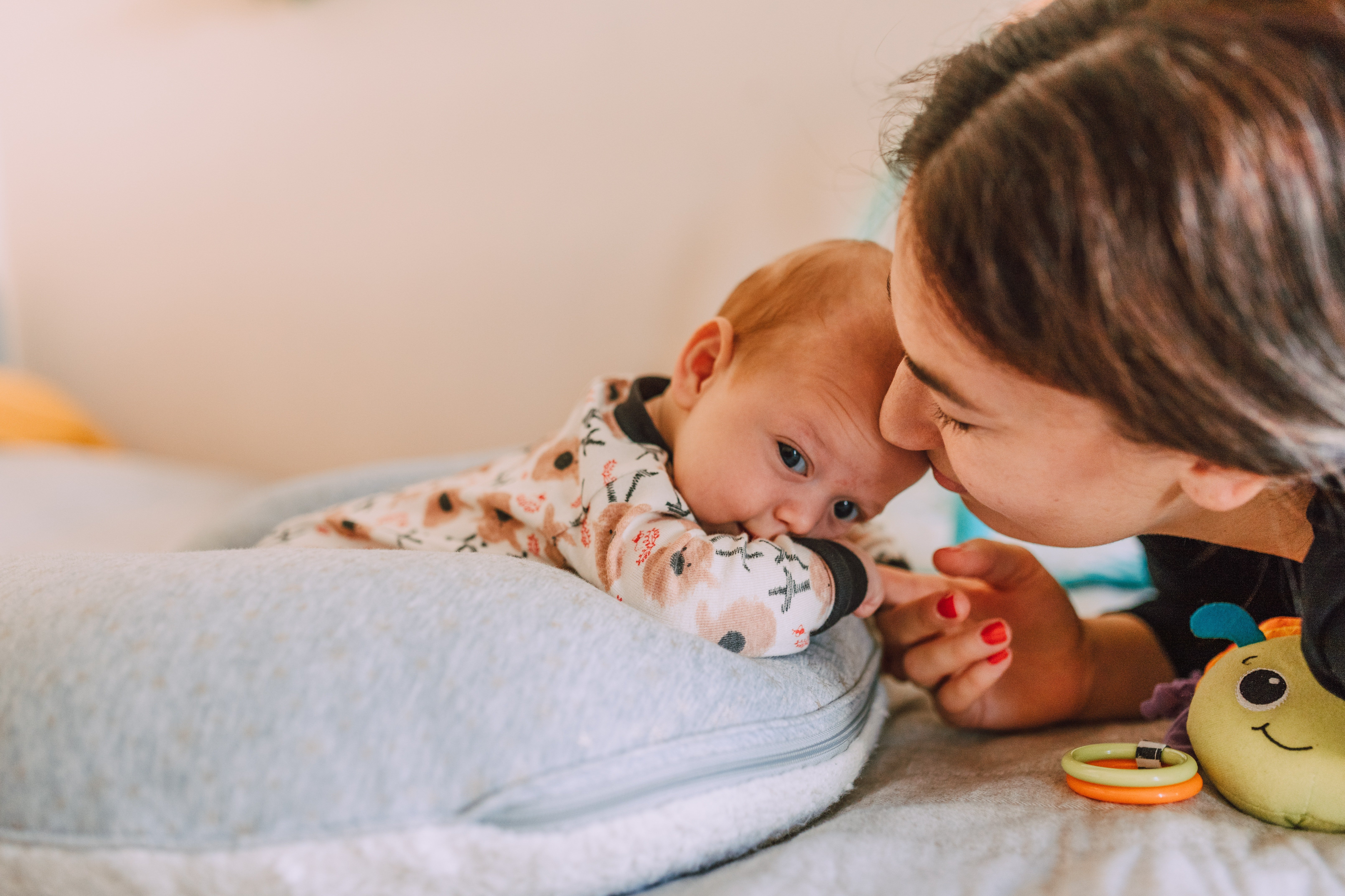 A woman playing with a newborn | Source: Pexels