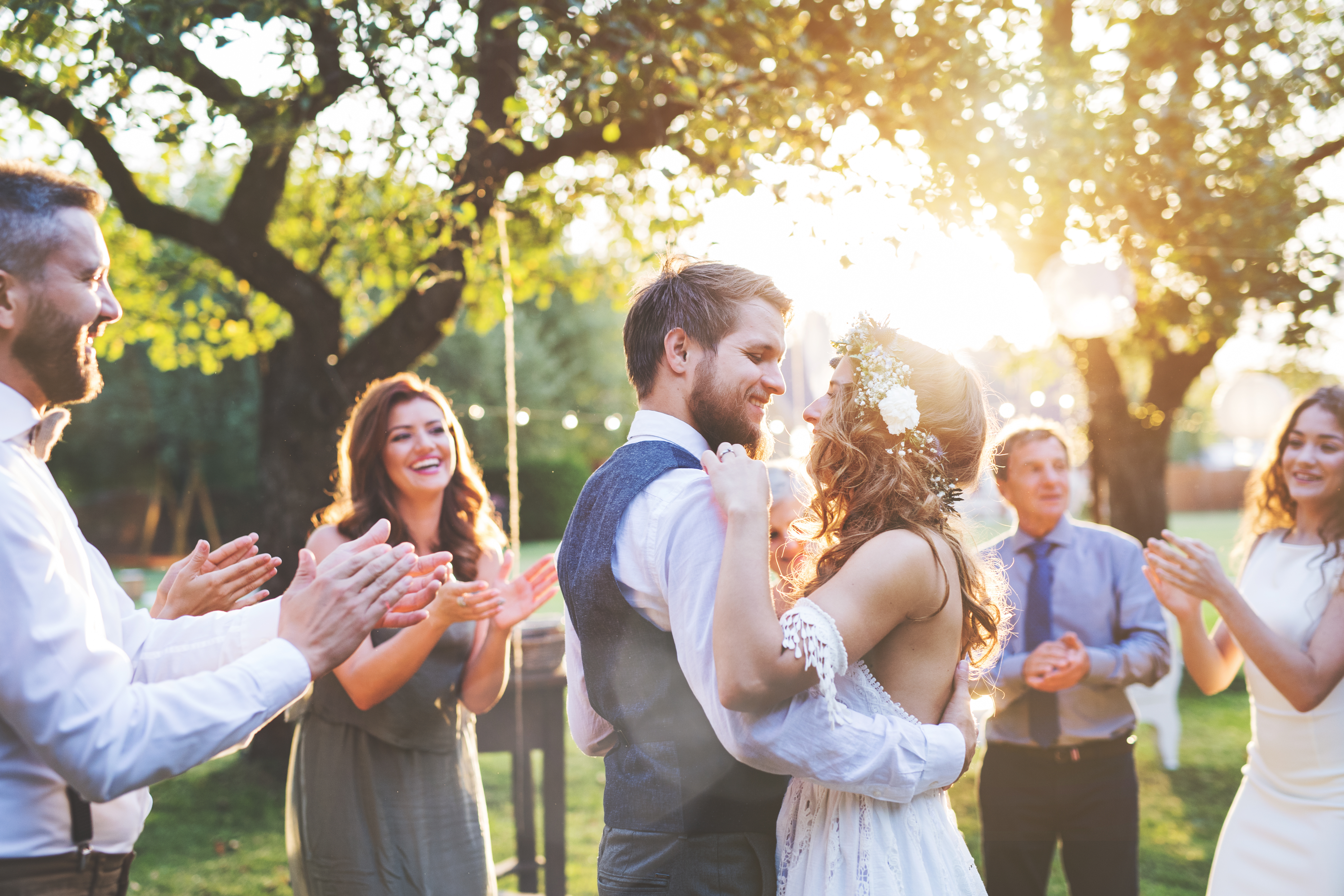 A happy couple surrounded by loved ones. | Source: Shutterstock