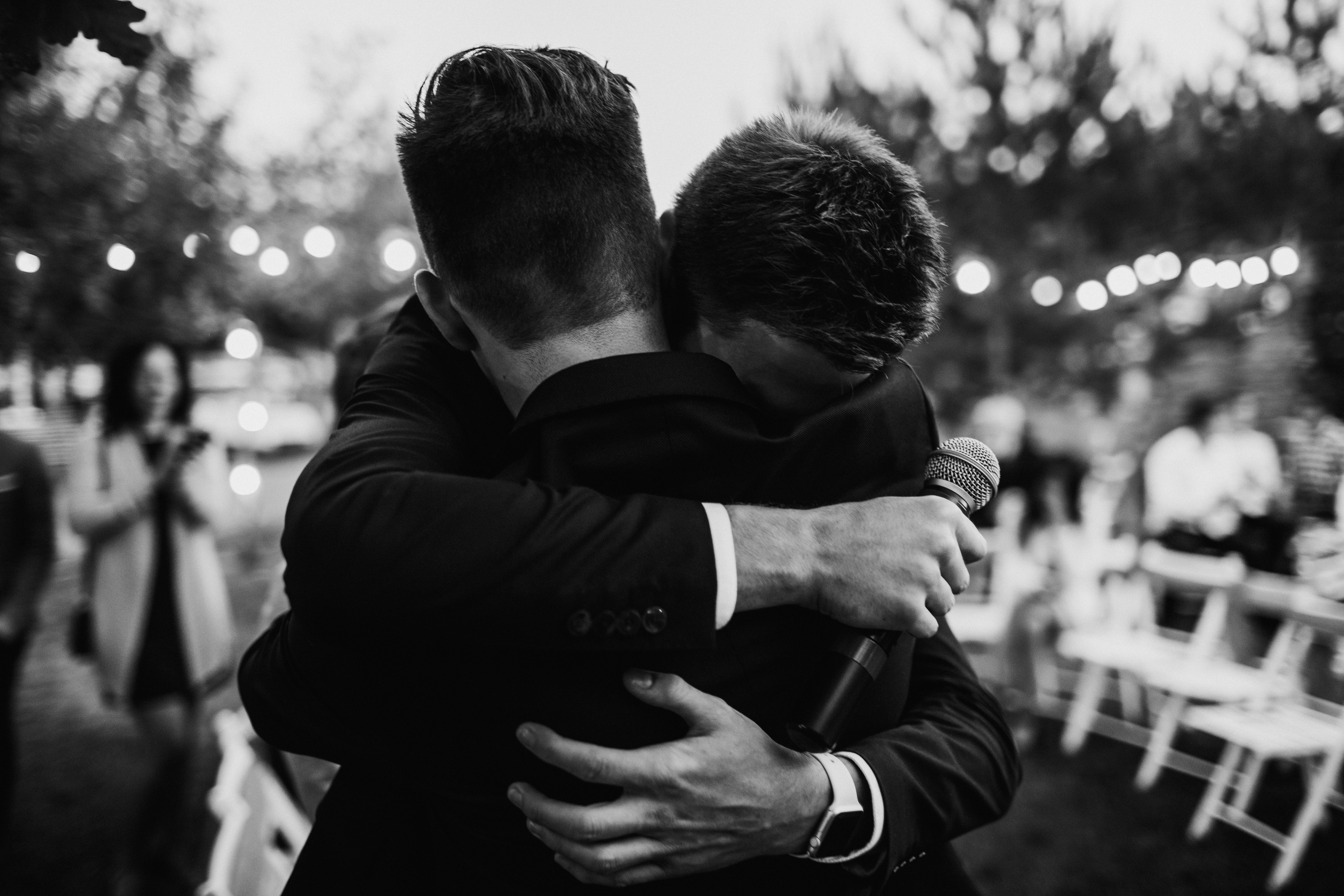 A groom hugs his brother | Source: Shutterstock