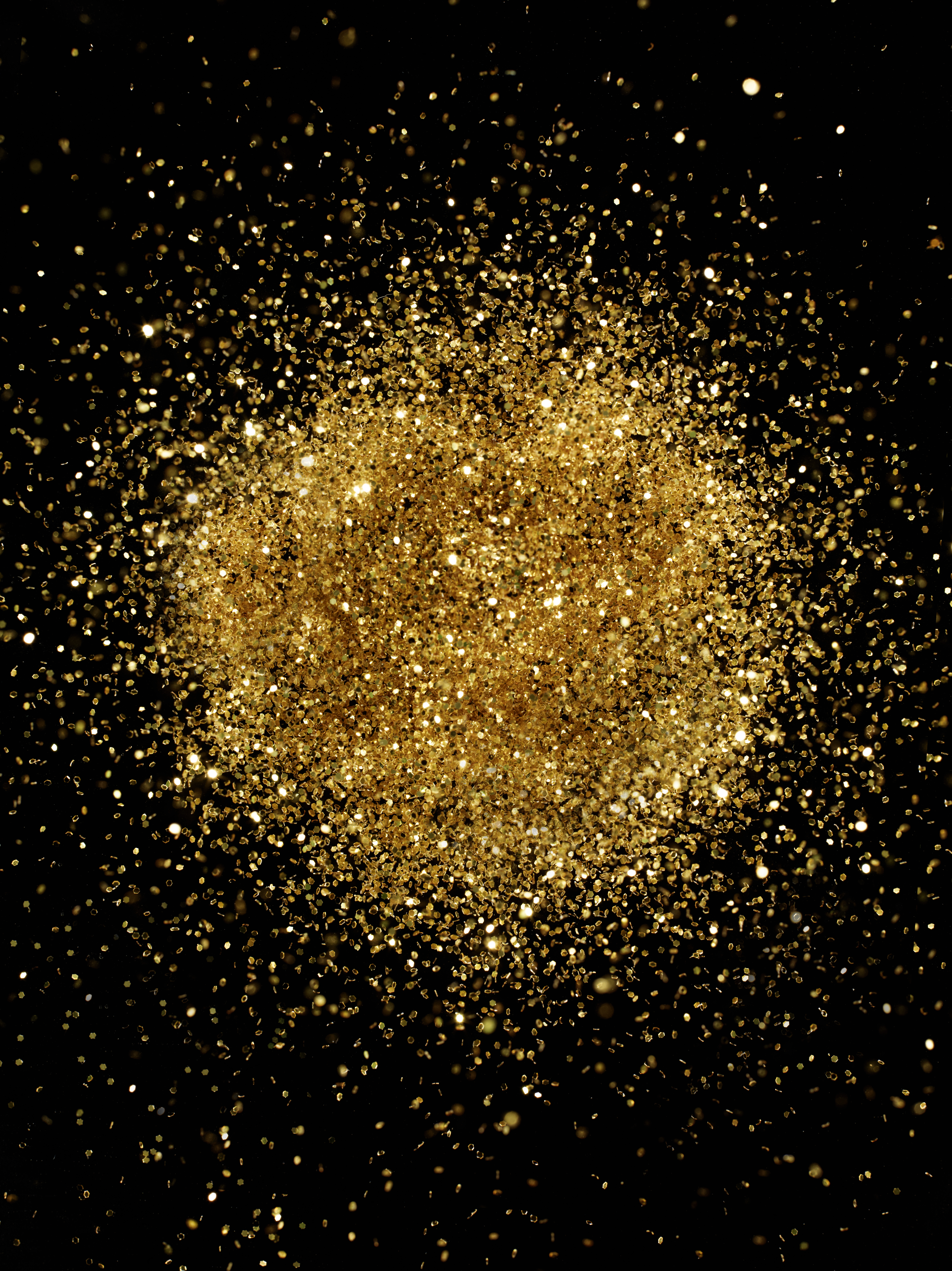 Gold glitter on a black background | Source: Getty Images