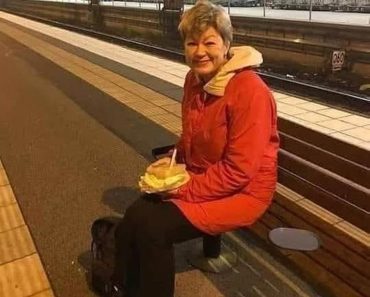 A woman is waiting for a train to return home