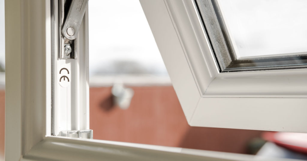 London, UK - Circa March 2019: Shallow focus of CE marking seen within newly installed double glazed windows. The mechanism for the small window can be seen, which is located at the back of the house.
