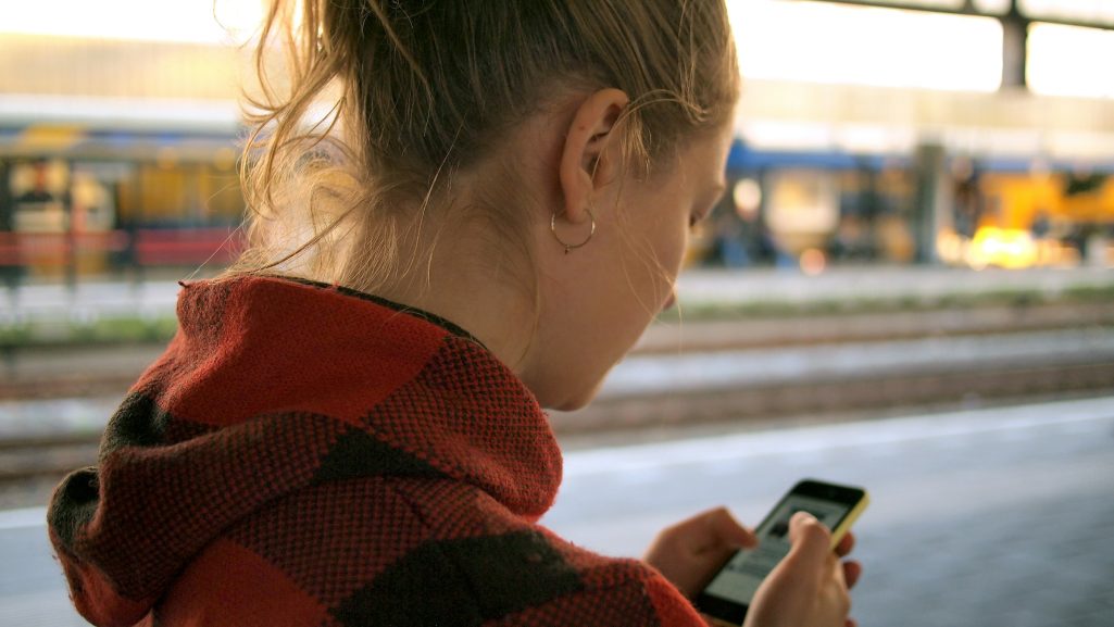 A young woman looking at her smartphone | Source: Unsplash