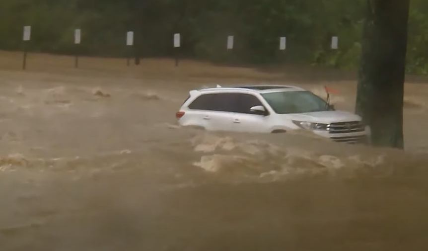 An SUV floating in the water, as seen in a video dated October 3, 2024 | Source: YouTube/Global News