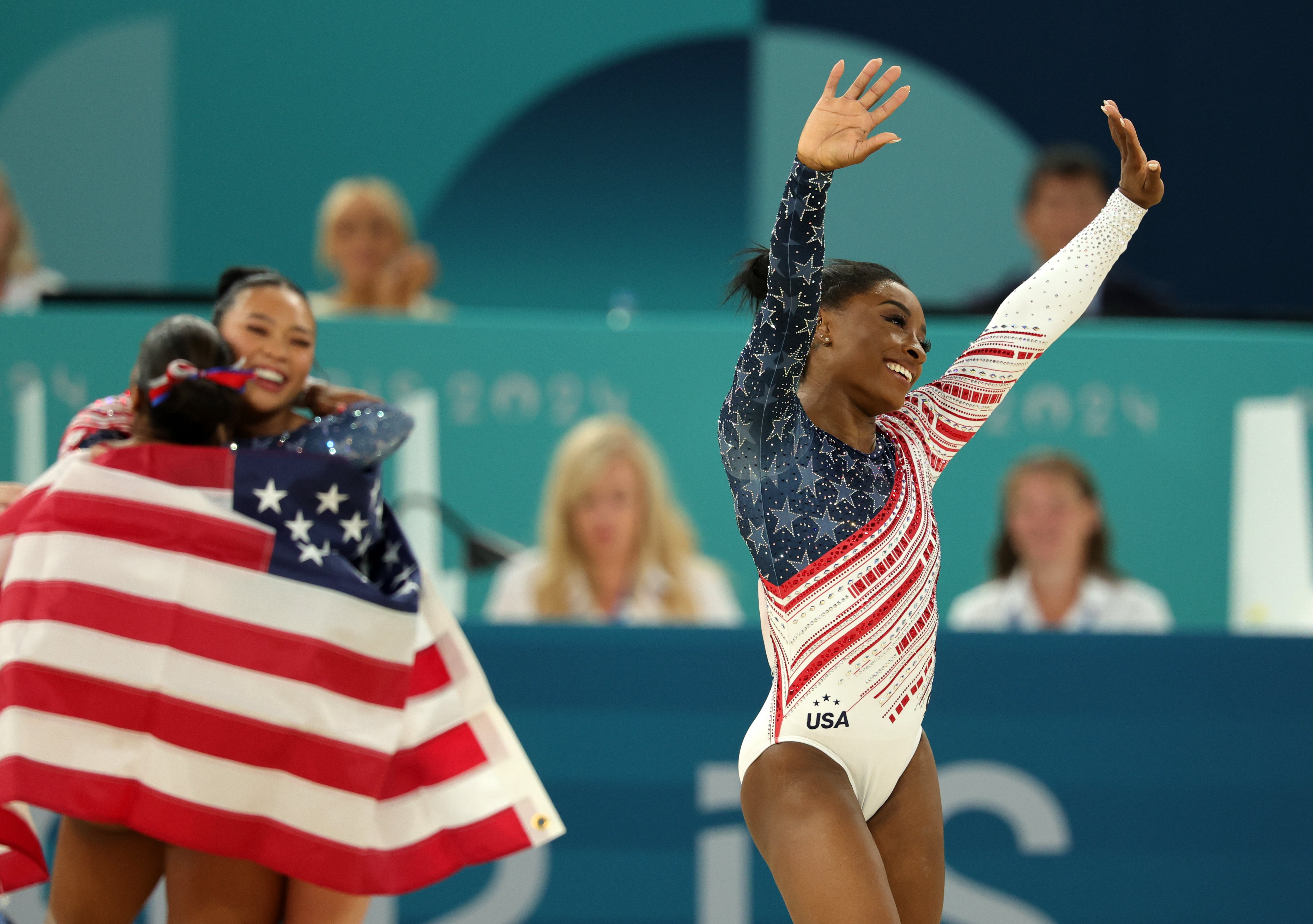 Simone Biles waves as she celebrates the gold medal win after the Artistic Gymnastics Women's Team Final at the 2024 Paris Olympics on July 30, 2024 | Source: Getty Images