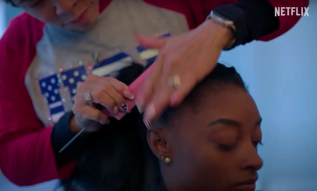 Nellie Biles doing Simone Biles's hair, posted on July 15, 2024 | Source: YouTube/Netflix