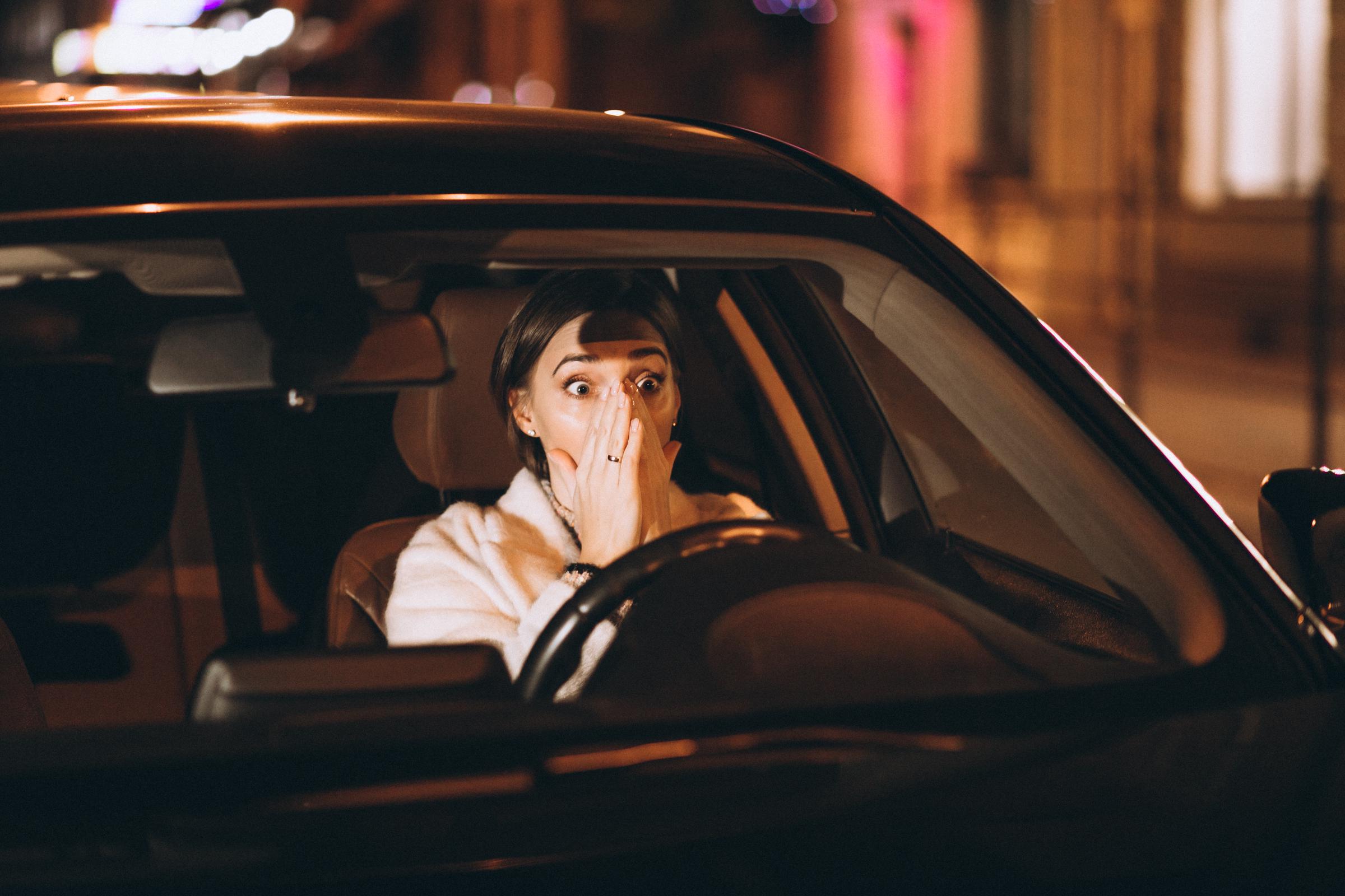 A shocked woman sitting in a car | Source: Freepik