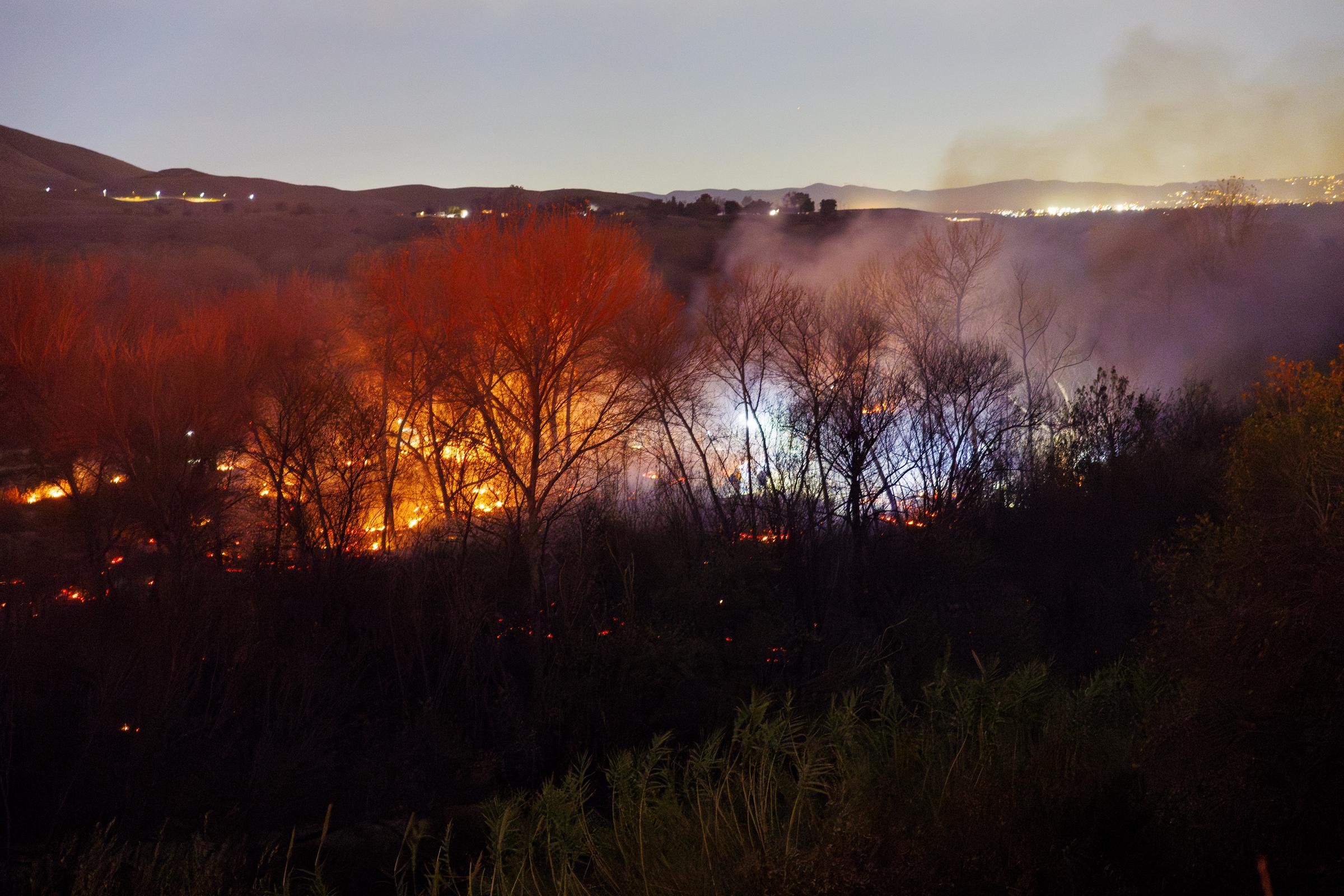 The Clay Fire continues smoldering in the Santa Ana River Bottom on January 21, 2025, in Jurupa Valley, California | Source: Getty Images