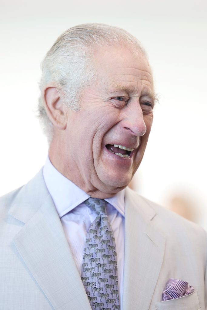 King Charles III laughs during a visit to Heriot-Watt University to open the Dubai campus at COP28 in Dubai, UAE, on November 30, 2023. | Source: Getty Images