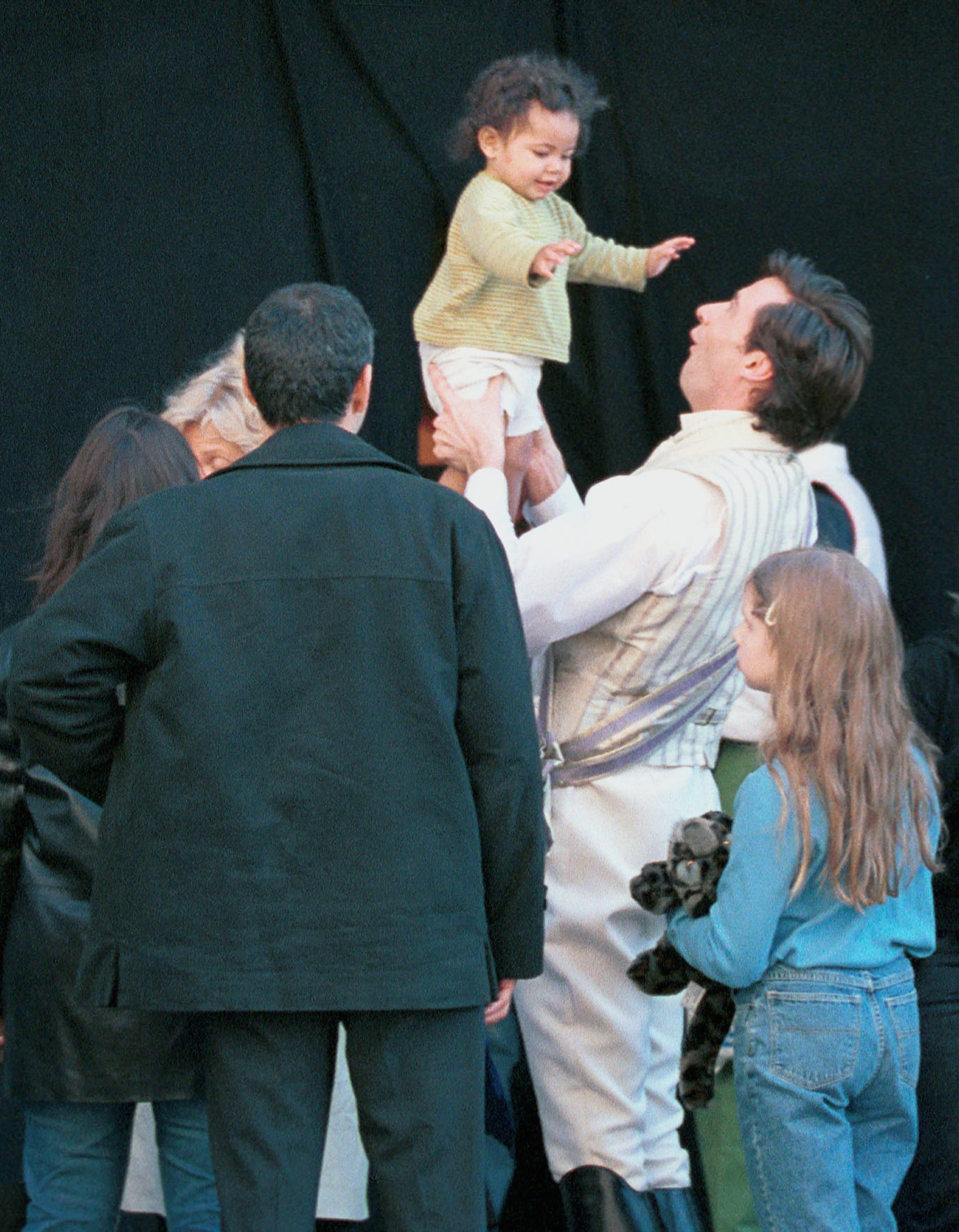 Hugh Jackman plays with Oscar Maximilian on the movie set of "Kate and Leopold" in New York City on April 5, 2001 | Source: Getty Images