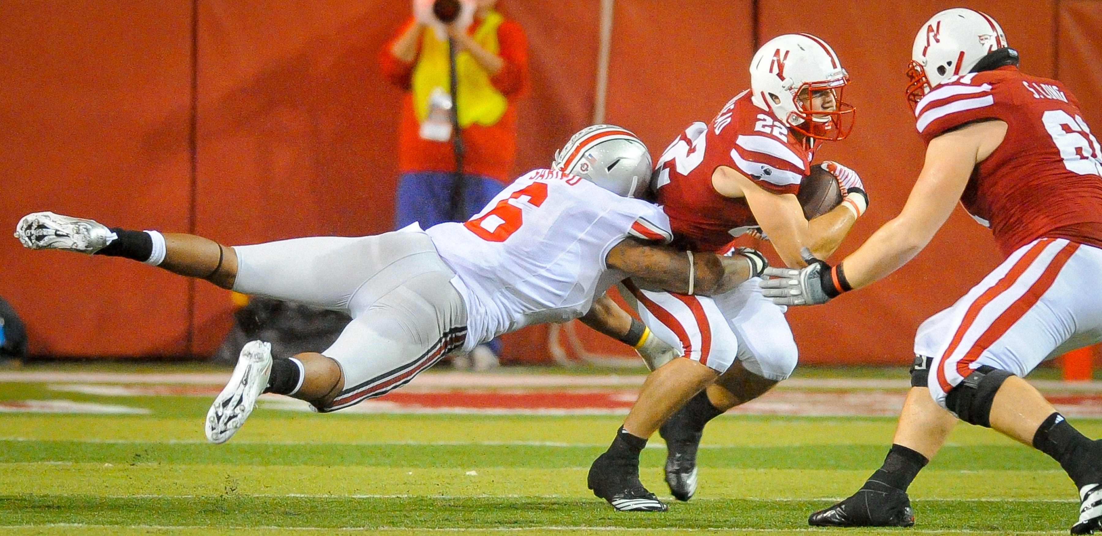 Rex Burkhead of the Nebraska Cornhuskers powers through linebacker Etienne Sabino of the Ohio State Buckeyes in Lincoln, Nebraska, on October 8, 2011 | Source: Getty Images