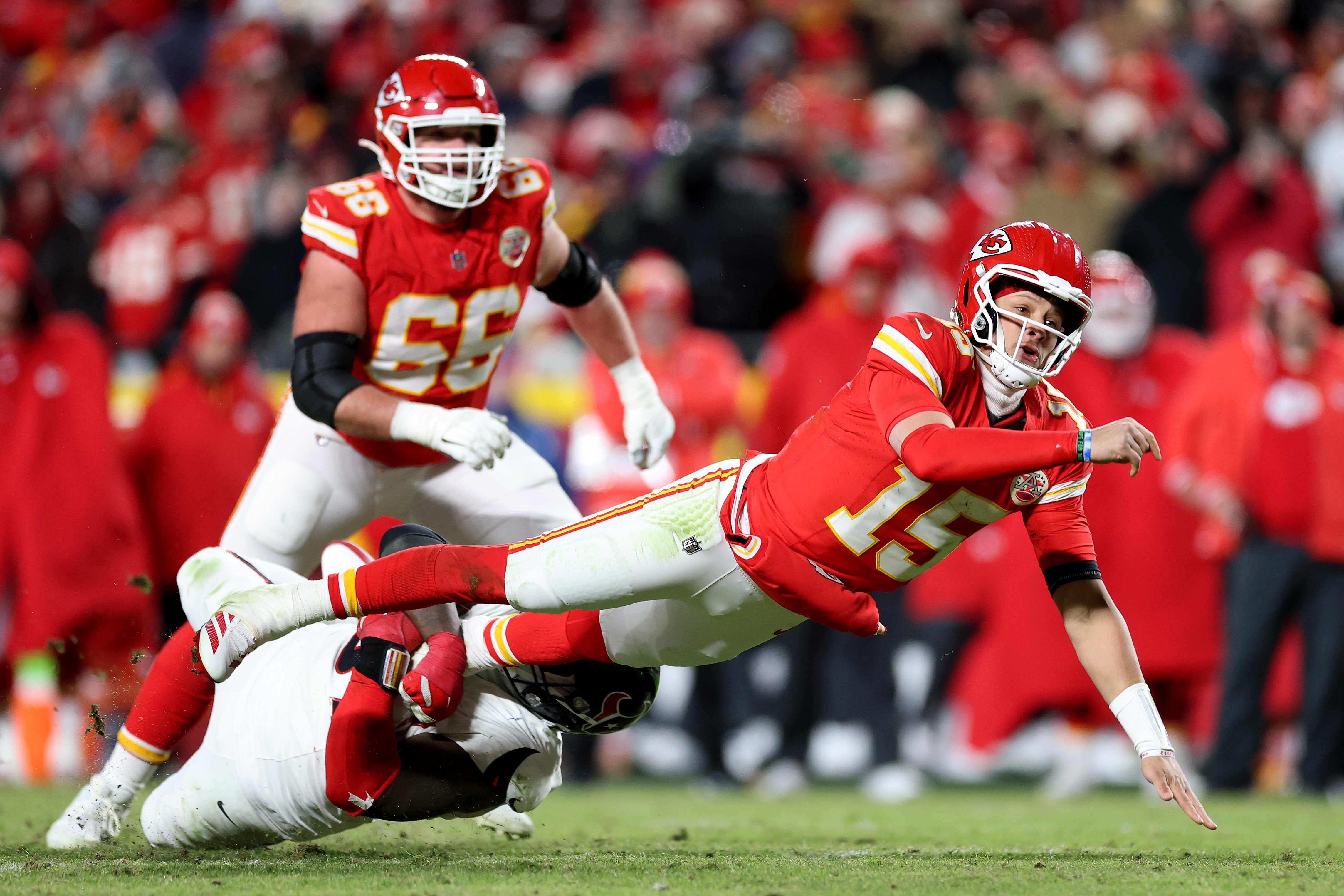 Patrick Mahomes #15 of the Kansas City Chiefs throws a touchdown pass to Travis Kelce #87 as he is tackled by Blake Fisher #57 of the Houston Texans during the fourth quarter in the AFC Divisional Playoff on January 18, 2025, in Kansas City, Missouri | Source: Getty Images