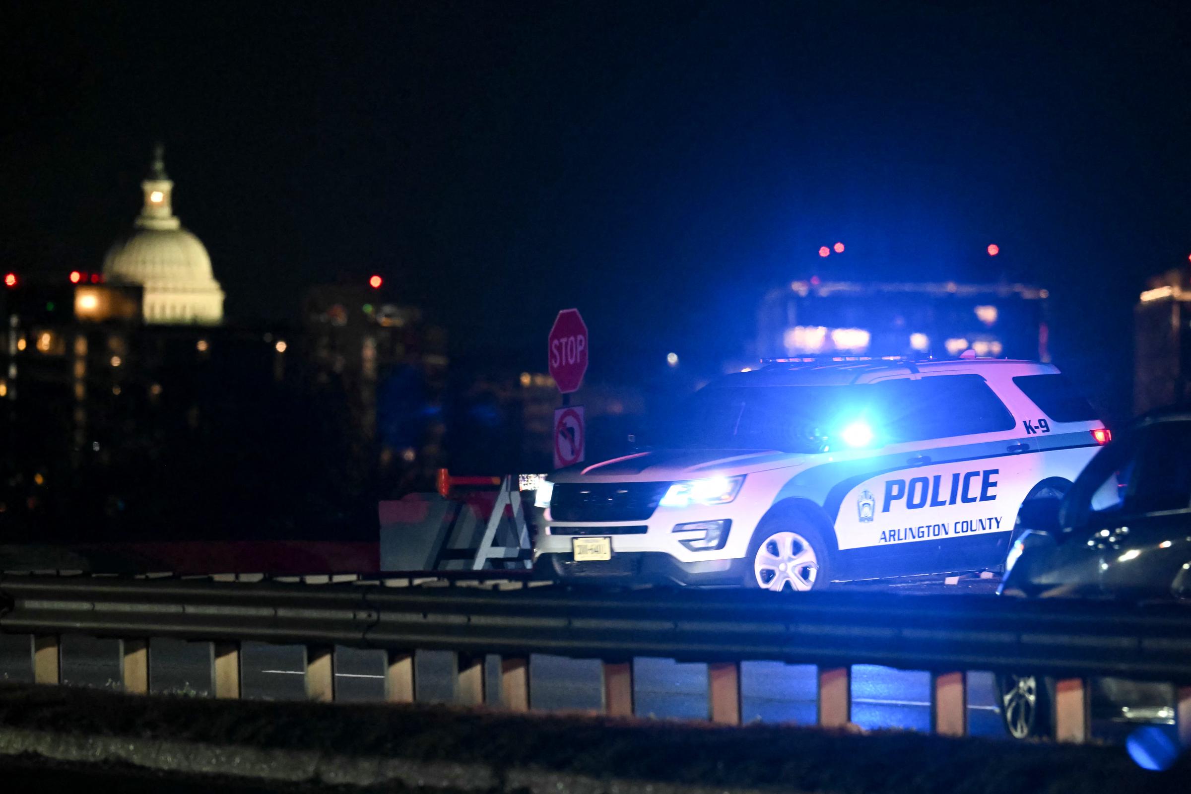 The US Capitol is seen in the distance as a police vehicle blocks the entrance to the Potomac River near Reagan National Airport after an air crash in Washington, DC, on January 29, 2025 | Source: Getty Images