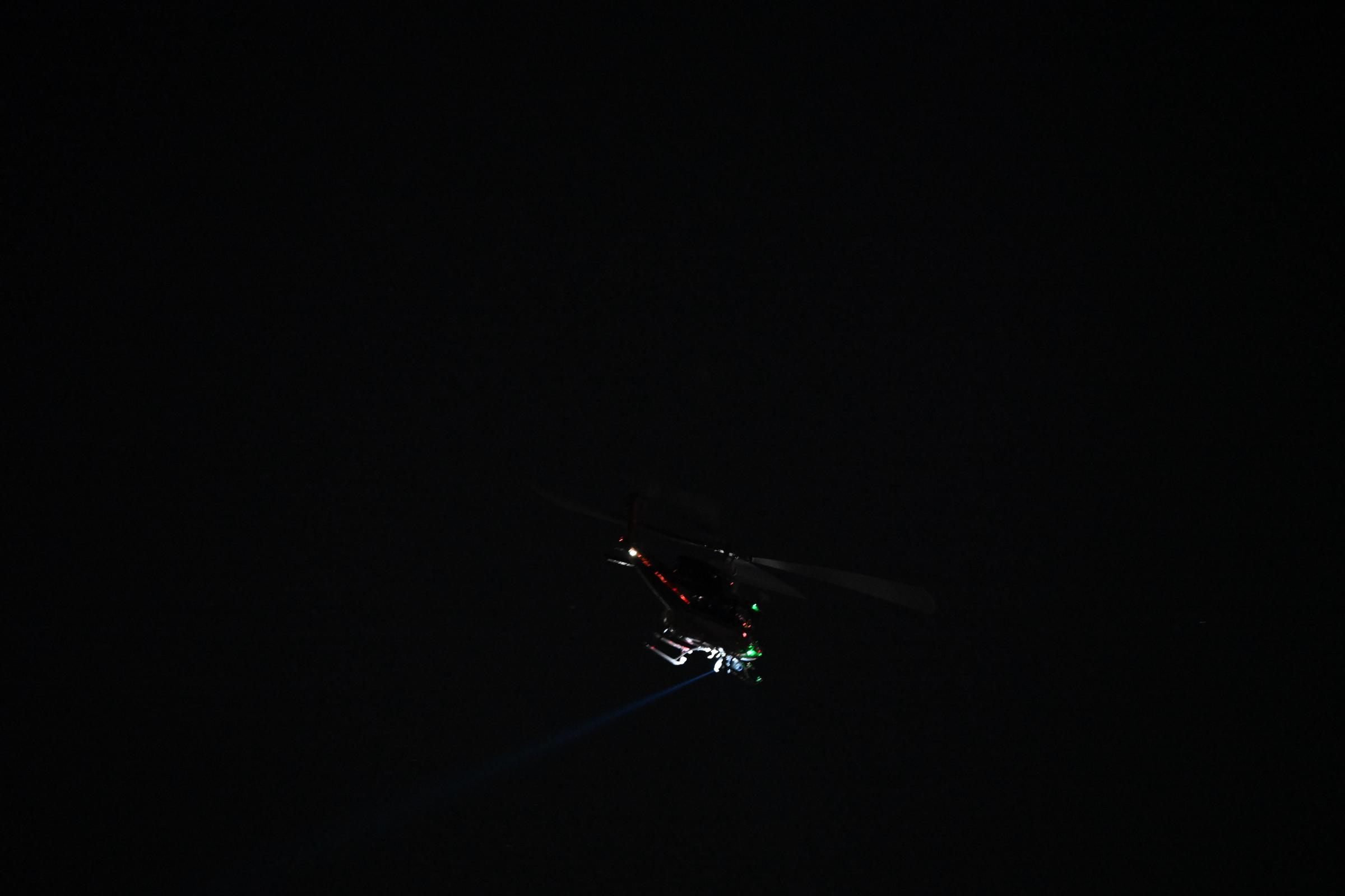 A helicopter flying over the area where the crash took place. | Source: Getty Images