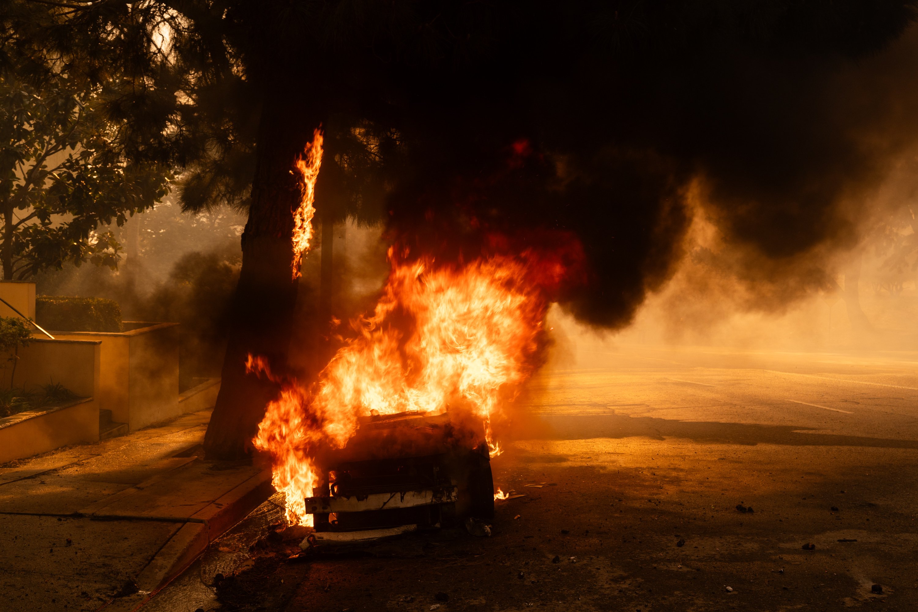 Smoke rises from a burning vehicle as a brush fire spreads in Pacific Palisades, Los Angeles, California, on January 7, 2025 | Source: Getty Images