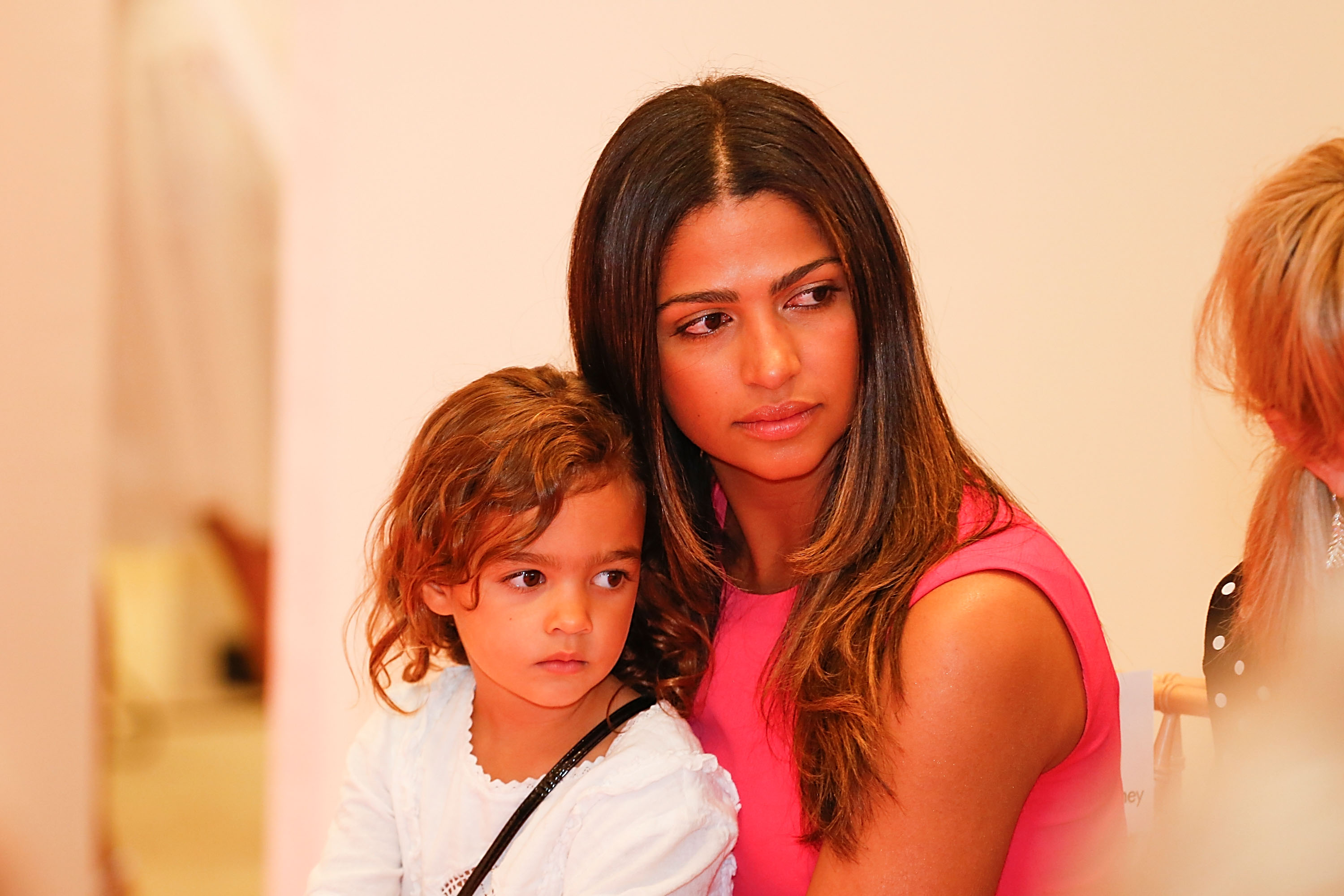 Camila Alves and Vida McConaughey watch the Badgley Mischka Fashion Event at Neiman Marcus in Austin, Texas, on April 25, 2014 | Source: Getty Images