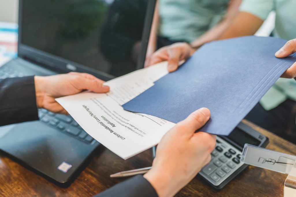 A person receiving printed documents | Source: Pexels