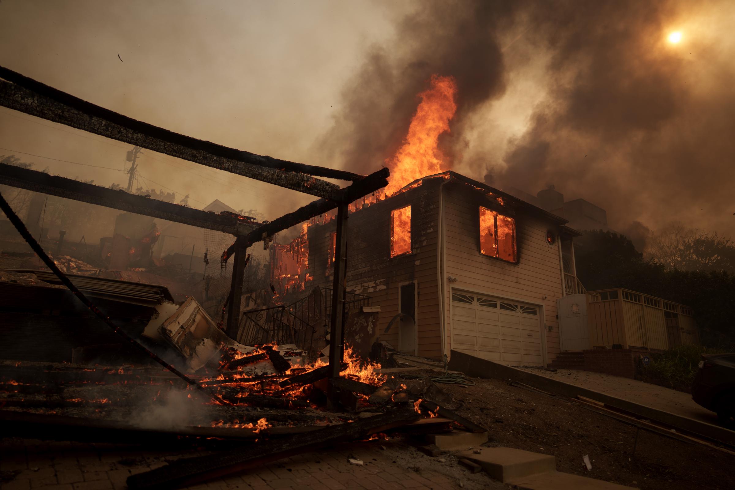 Flames from the Palisades Fire burn a home on January 8, 2025, in the Pacific Palisades neighborhood of Los Angeles, California | Source: Getty Images