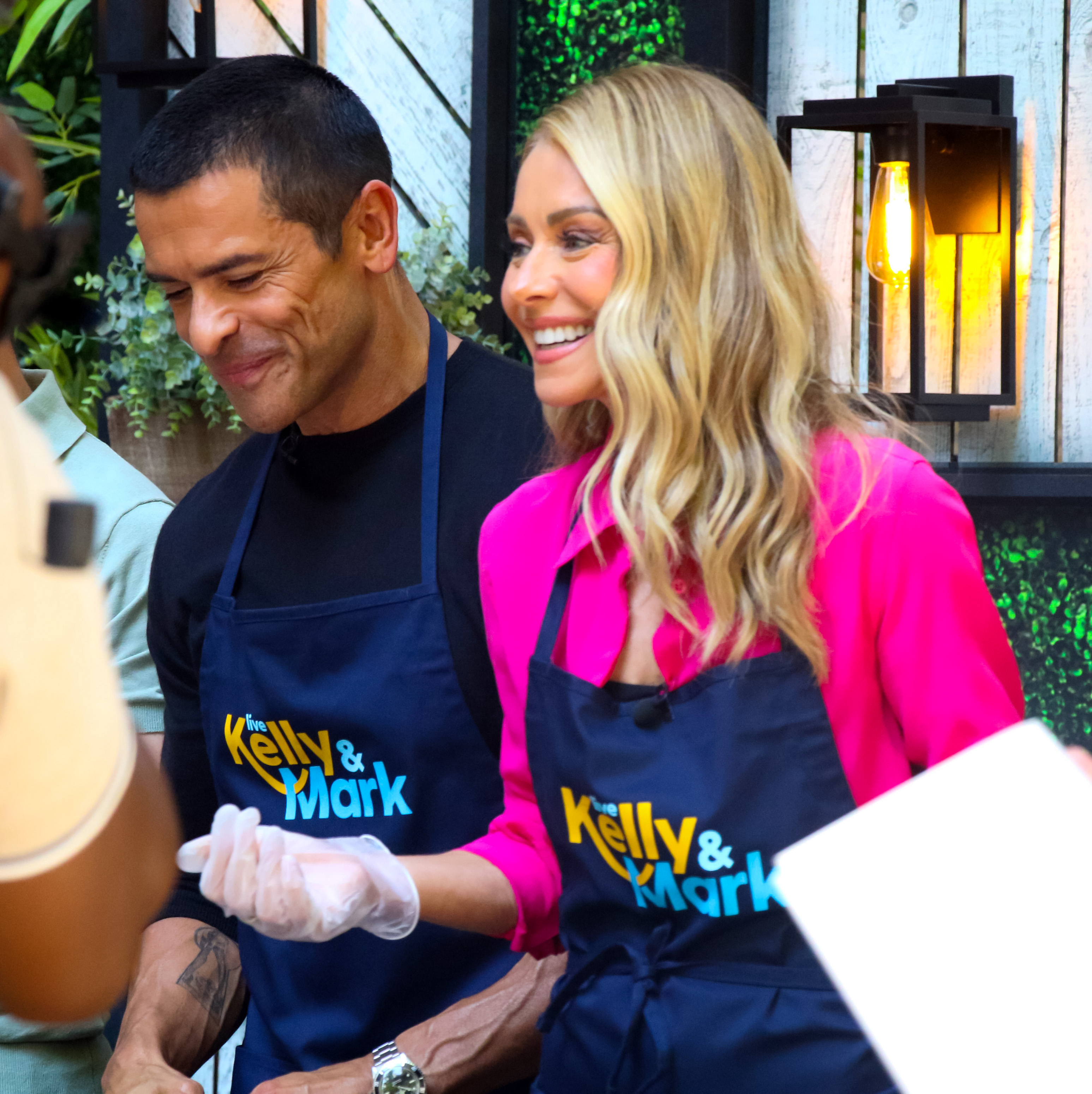 Mark Consuelos and Kelly Ripa are seen grilling at the "Live with Kelly and Mark" show in New York City, on July 17, 2024 | Source: Getty Images