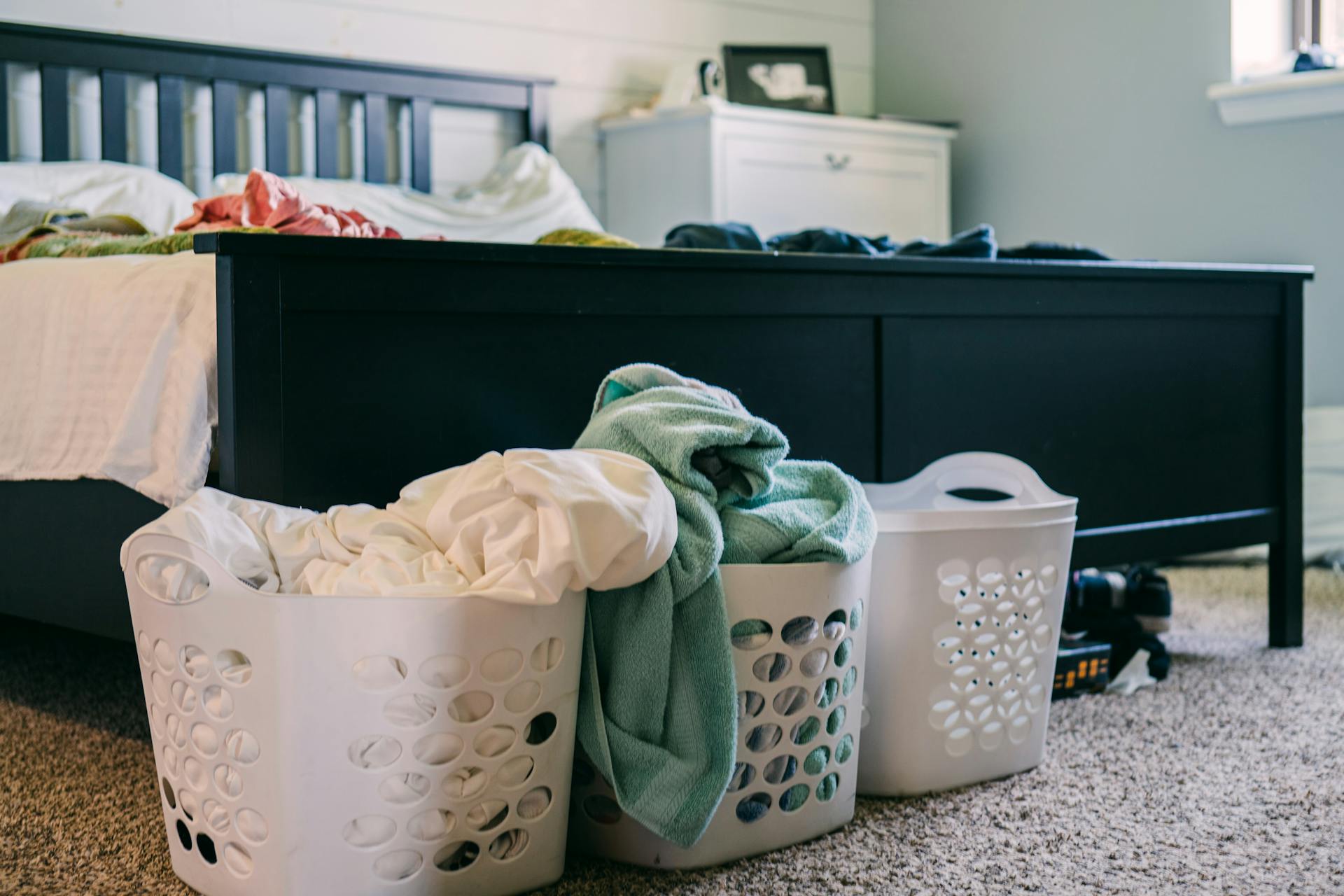 Laundry hampers in a bedroom | Source: Pexels