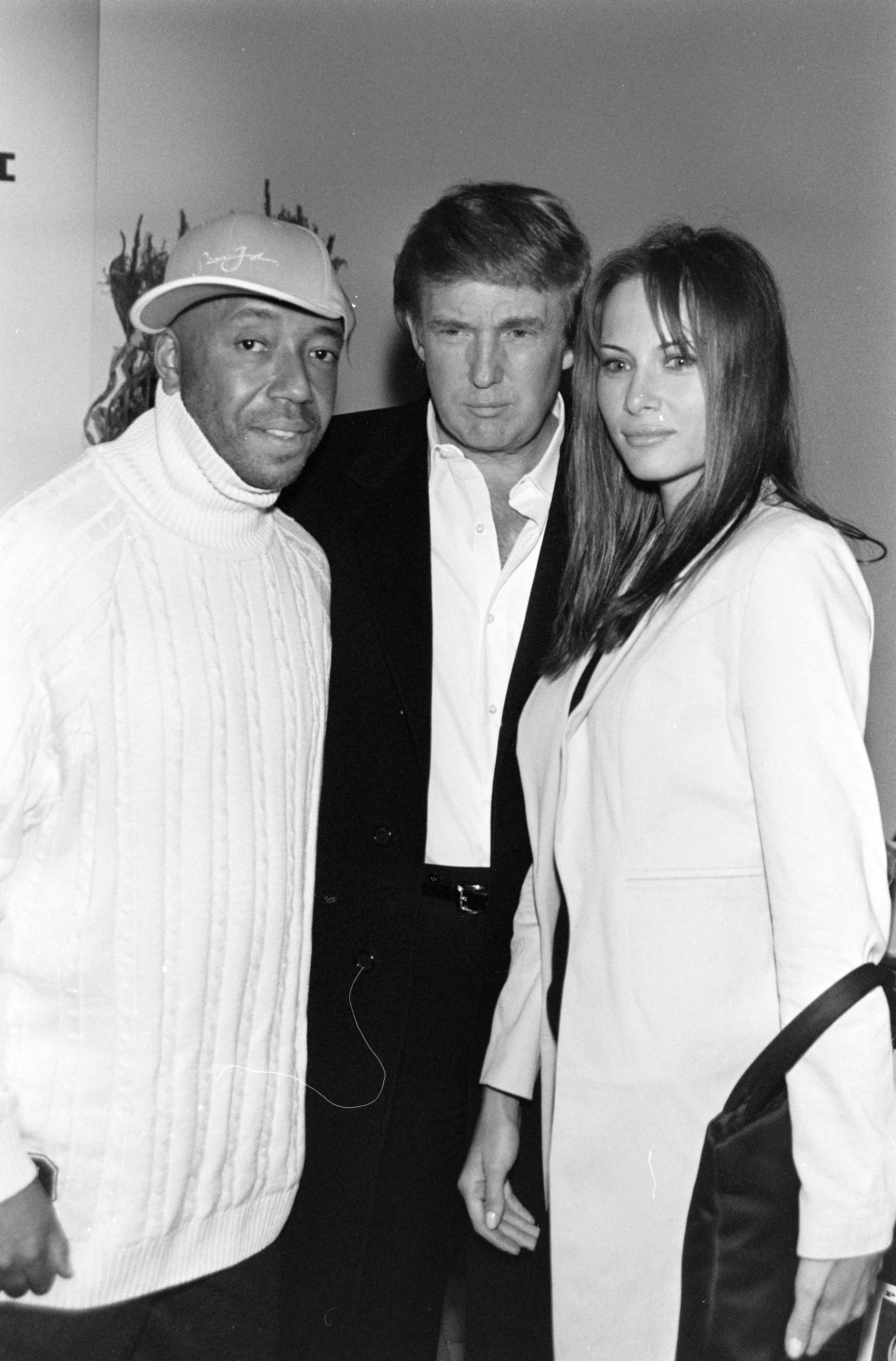 Russell Simmons with Donald and Melania Trump at the Phat Farm Spring 1998 Ready to Wear Fashion Show. | Source: Getty Images