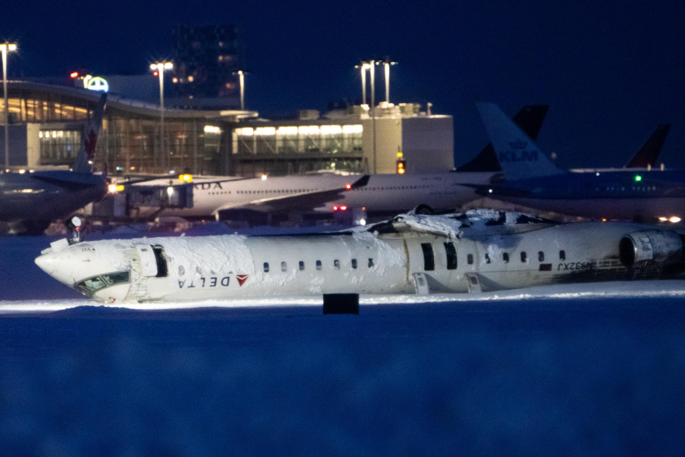 A view of the Delta plane overturned after it crash landed in Toronto, Canada on February 18, 2025. | Source: Getty Images