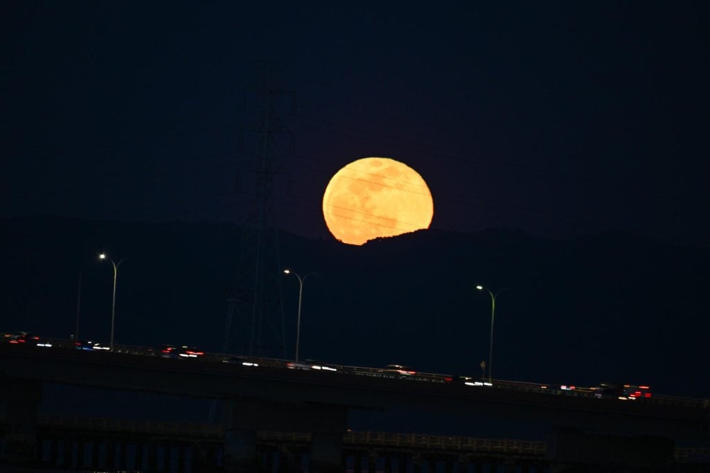 Full Snow Moon rises over San Mateo Bridge of San Francisco Bay in San Mateo, California on February 24, 2024 | Source: Getty Images