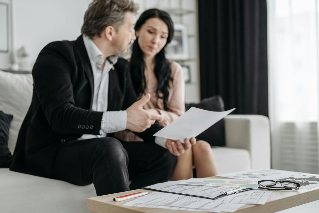 A woman and a man going through paperwork in an office | Source: Pexels