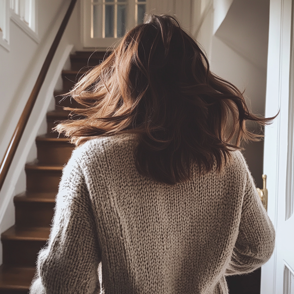 A woman running up the stairs | Source: Midjourney