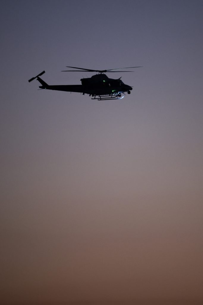 A helicopter flies near the crash site on January 30, 2025, in Arlington, Virginia. | Source: Getty Images