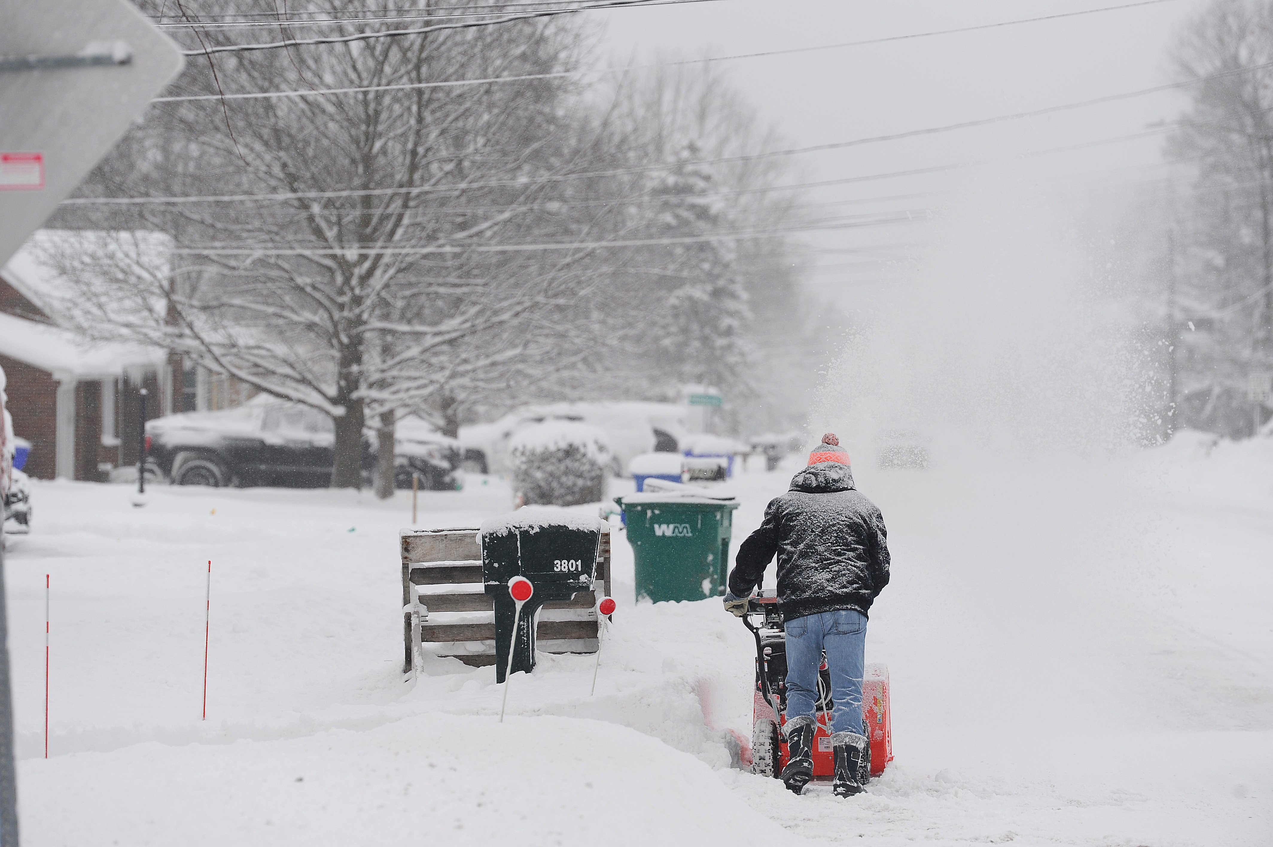 A resident clears lake effect snow outside of his home on January 21, 2025, in Hamburg, New York.