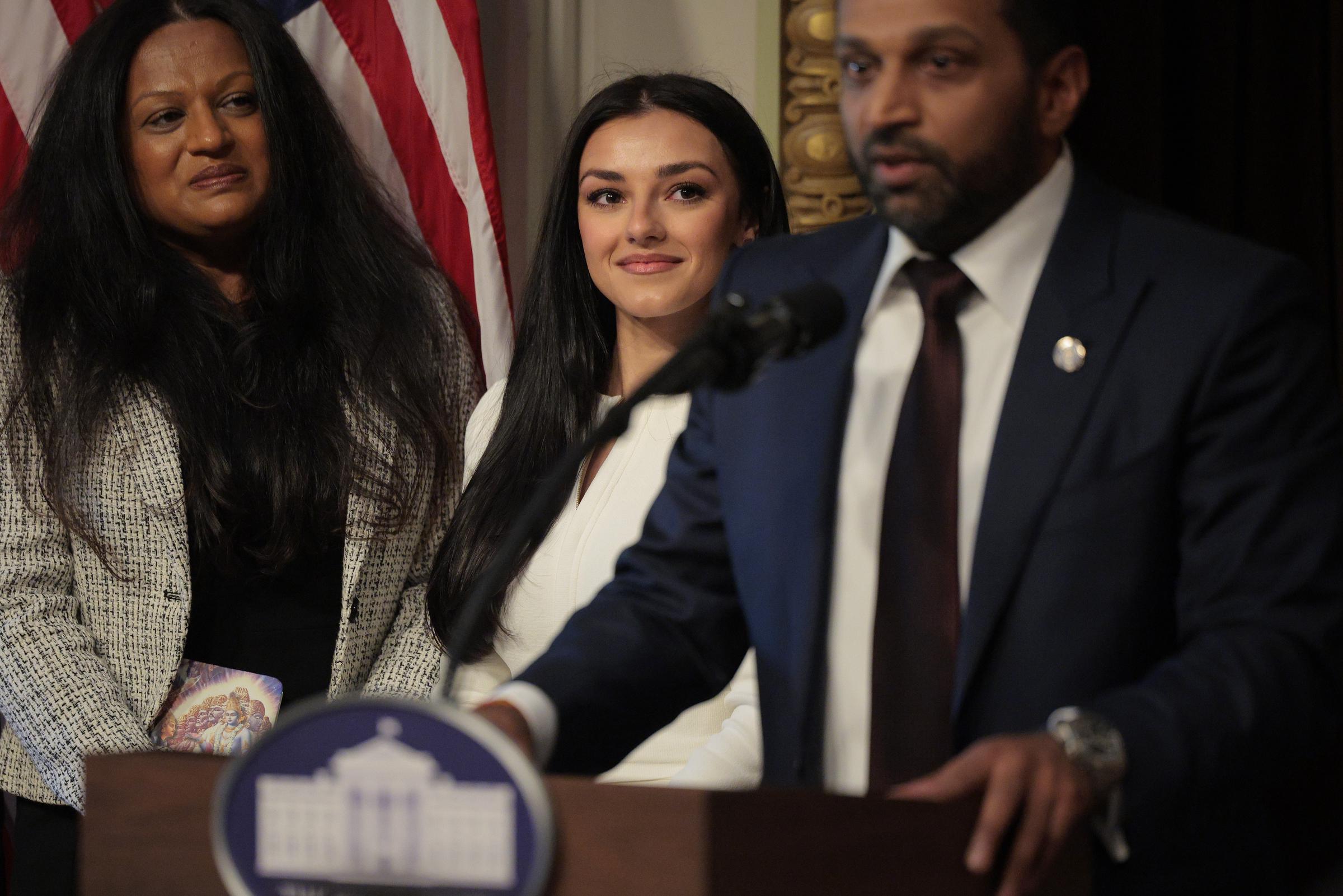 New Federal Bureau of Investigation Director Kash Patel speaking as his girlfriend, Alexis Wilkins, looks on during his swearing-in ceremony in the Indian Treaty Room in the Eisenhower Executive Office Building on February 21, 2025, in Washington, DC. | Source: Getty Images