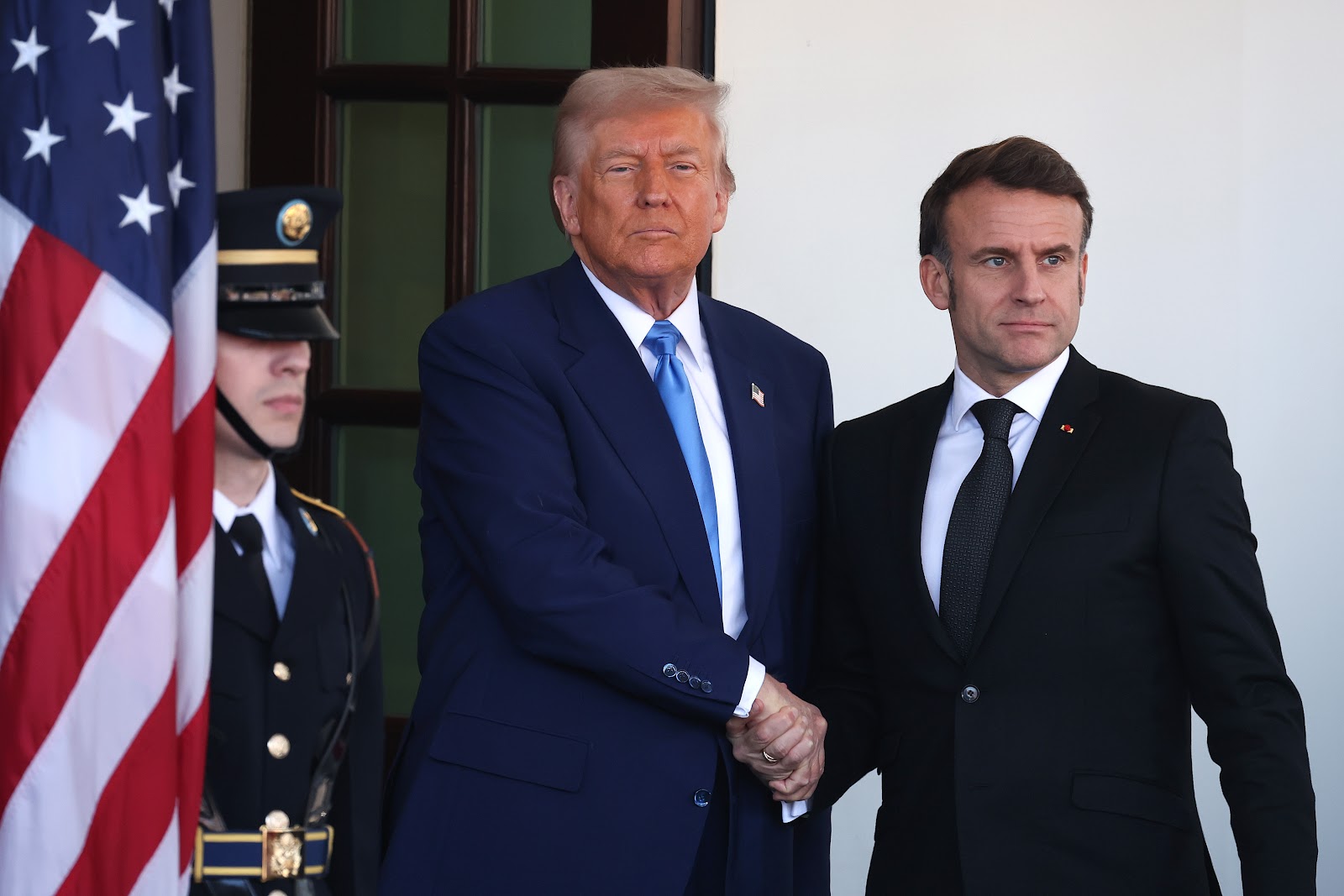 Donald Trump and Emmanuel Macron shaking hands. | Source: Getty Images