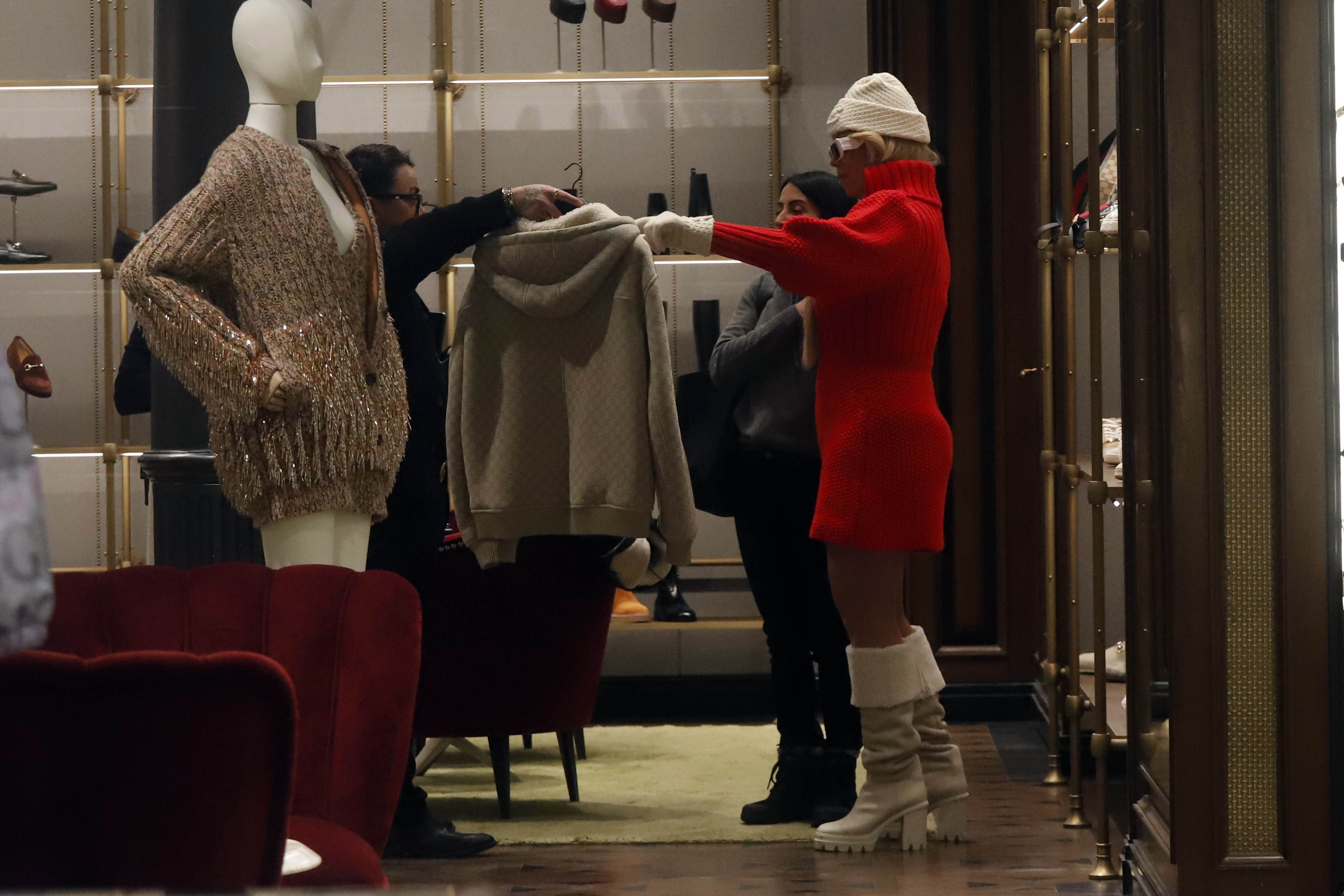 Mariah Carey taking a look at a jacket. | Source: Getty Images