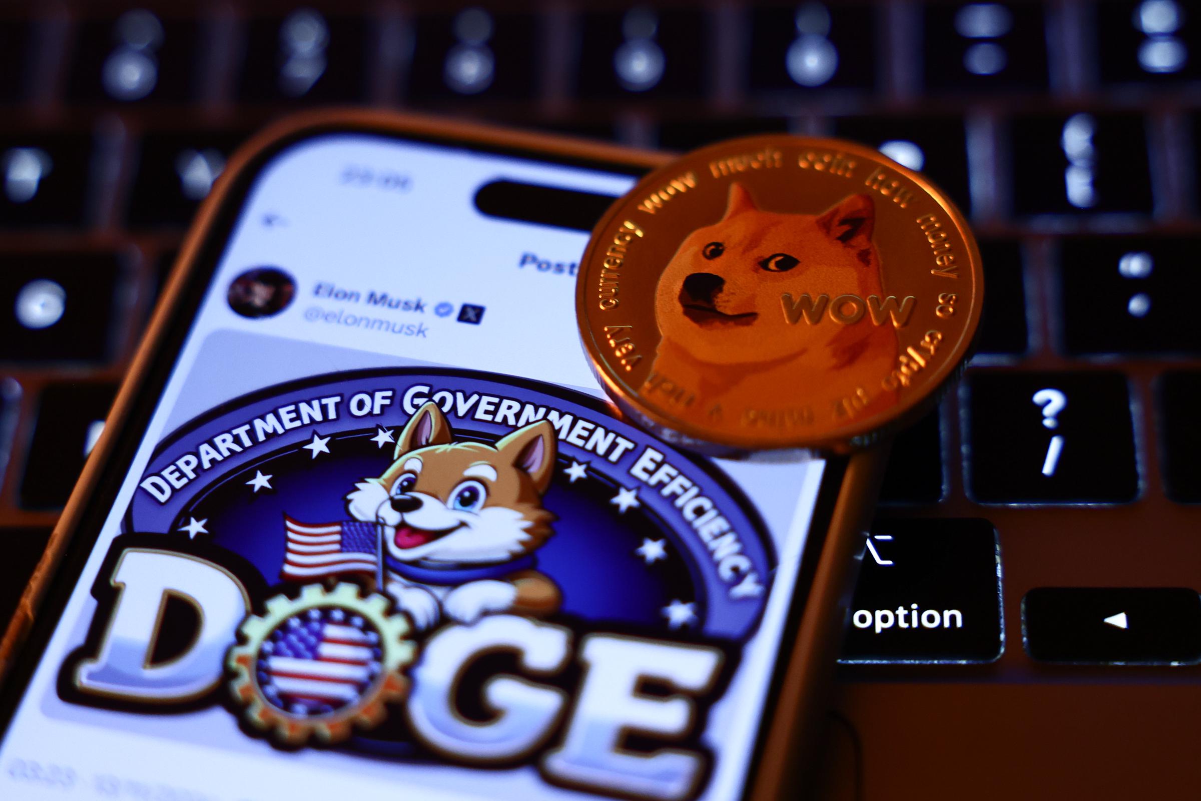 A laptop keyboard, Elon Musk's post about DOGE on X displayed on a phone screen, and a representation of Dogecoin cryptocurrency are seen in this illustration photo taken in Krakow, Poland on November 13, 2024 | Source: Getty Images