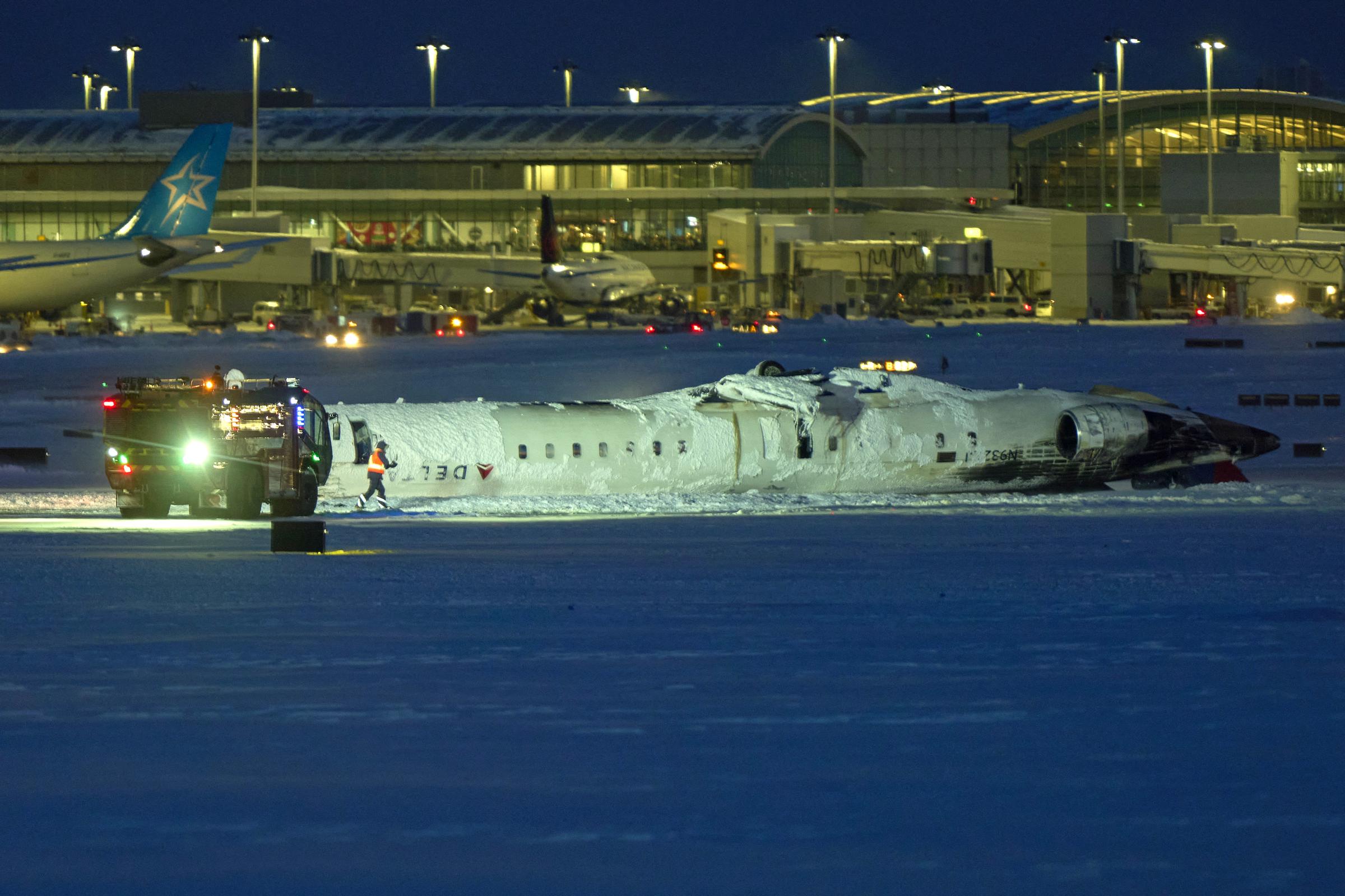 A view of the Delta plane laying upside down at the airport. | Source: Getty Images