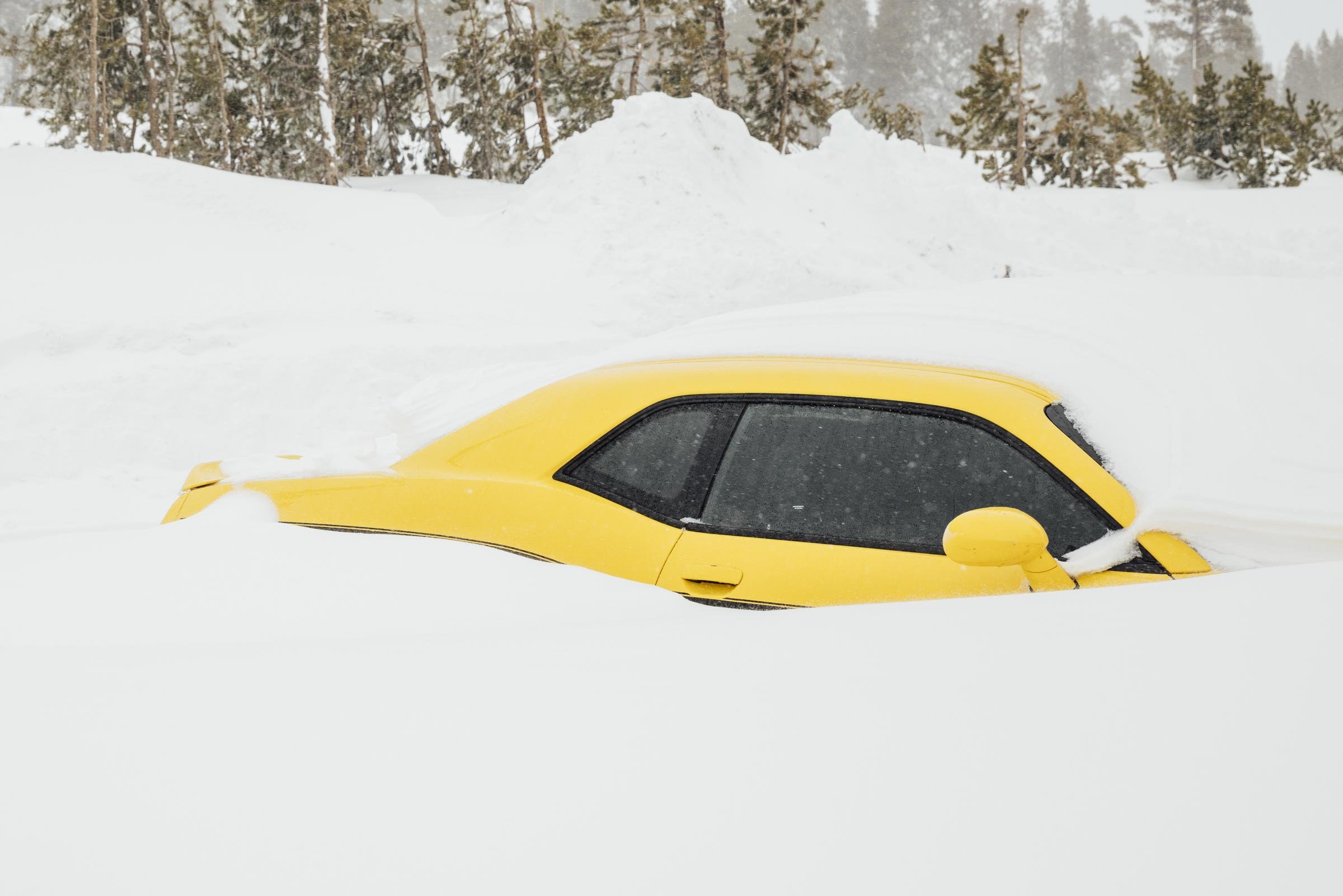 A Dodge Challenger pictured buried in snow on February 14, 2025, in Soda Springs, California. | Source: Getty Images