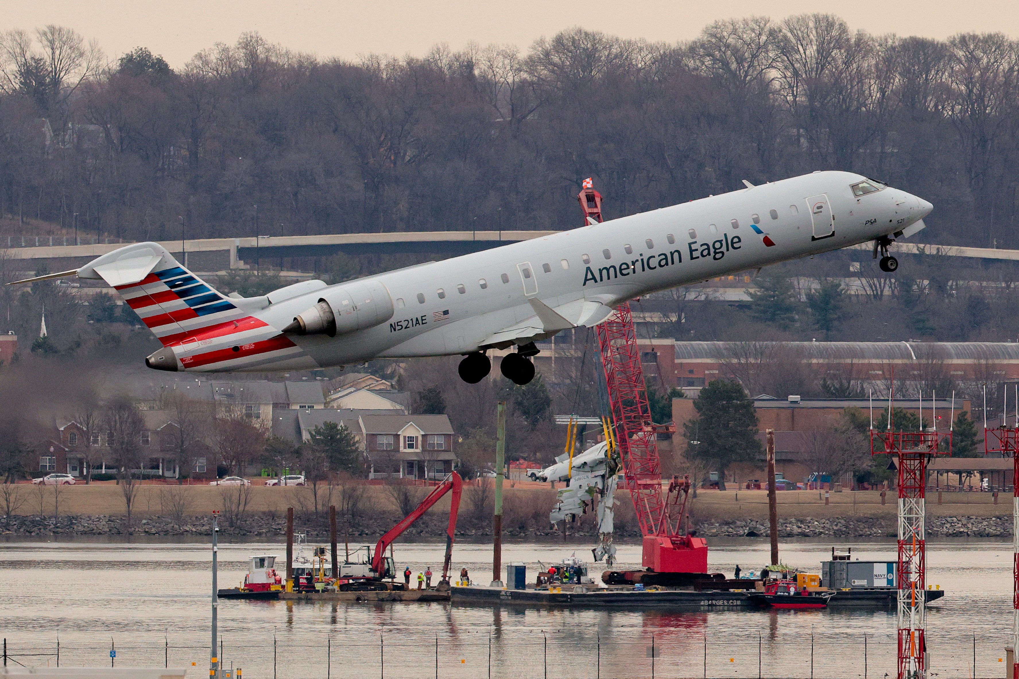 An airplane takes off as recovery efforts continue after the American Airlines plane and Black Hawk helicopter crash near Reagan National Airport on February 3, 2025, in Arlington, Virginia | Source: Getty Images